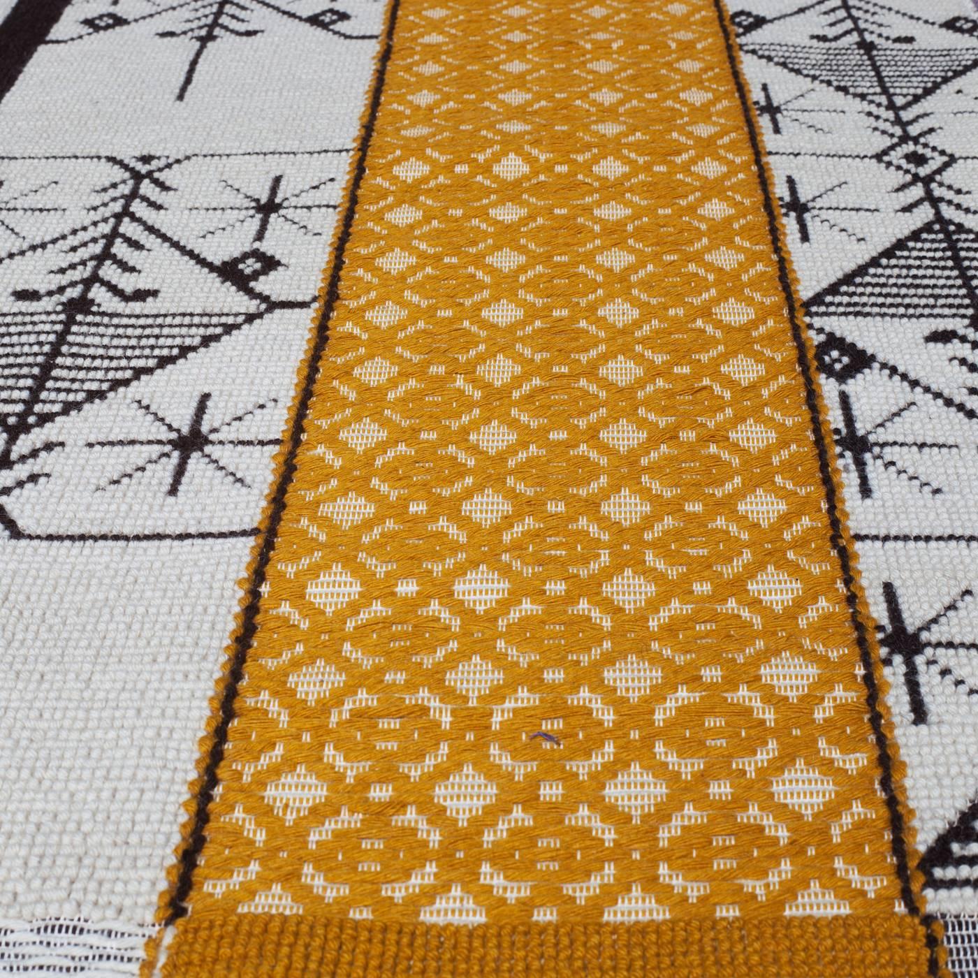 Expert hand craftsmanship was combined with the vision of the designer in this extraordinary work of art, also functioning as a rug. The graphic elements forming geometric patterns on this piece are complemented by the softness of the wool yarn and