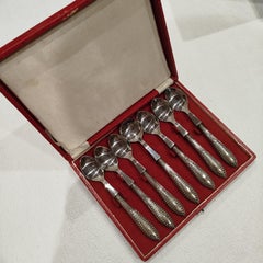Case Containing a Set of 6 Teaspoons and a Sugar Spoon, in Silver.