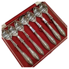 Case Containing a Set of 6 Teaspoons and a Sugar Spoon, in Silver.