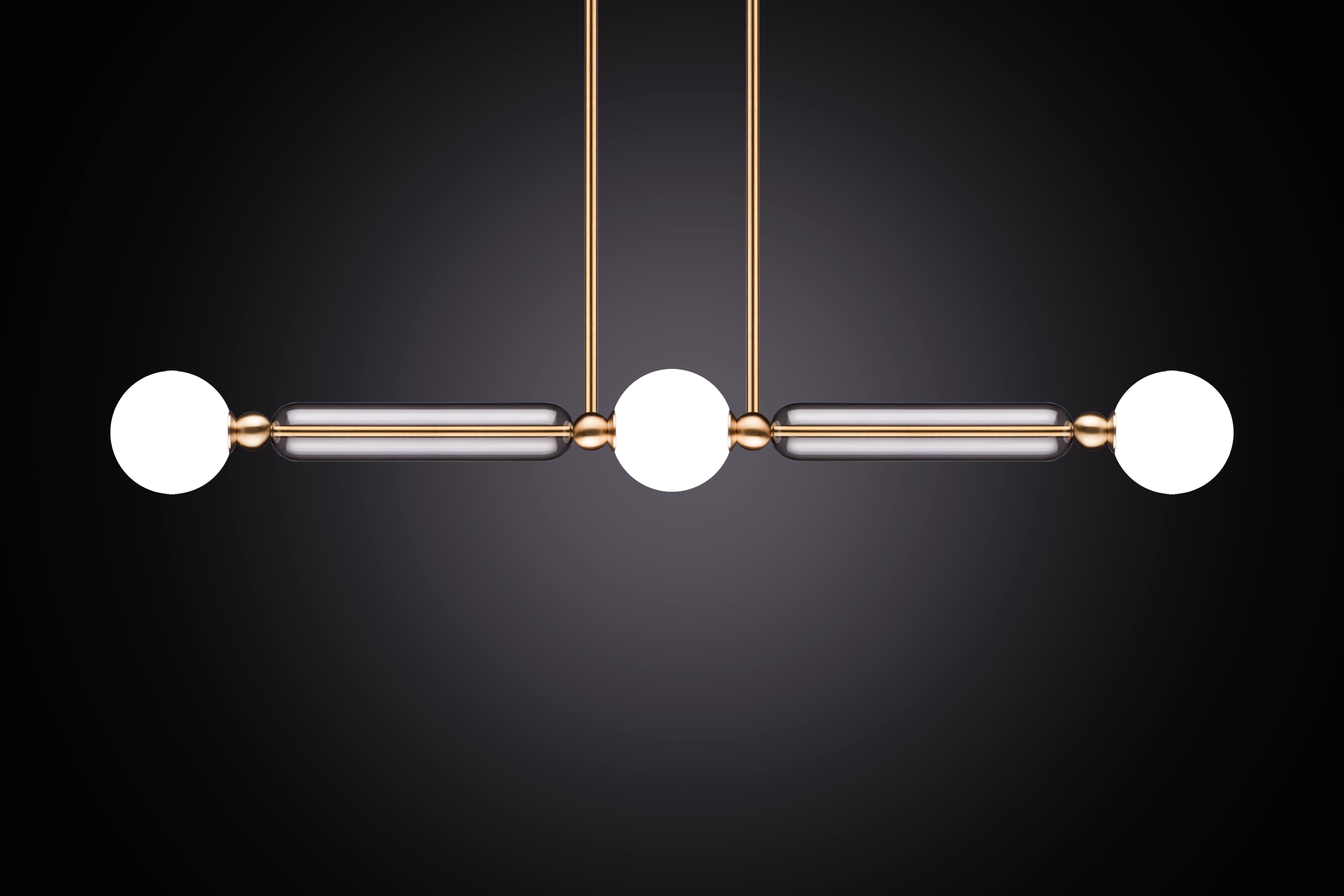 Case comprises of delicate brass arms encased in crystal glass tubes. All joined with solid brass sphere connectors to 
allow for multiple configurations and size options.