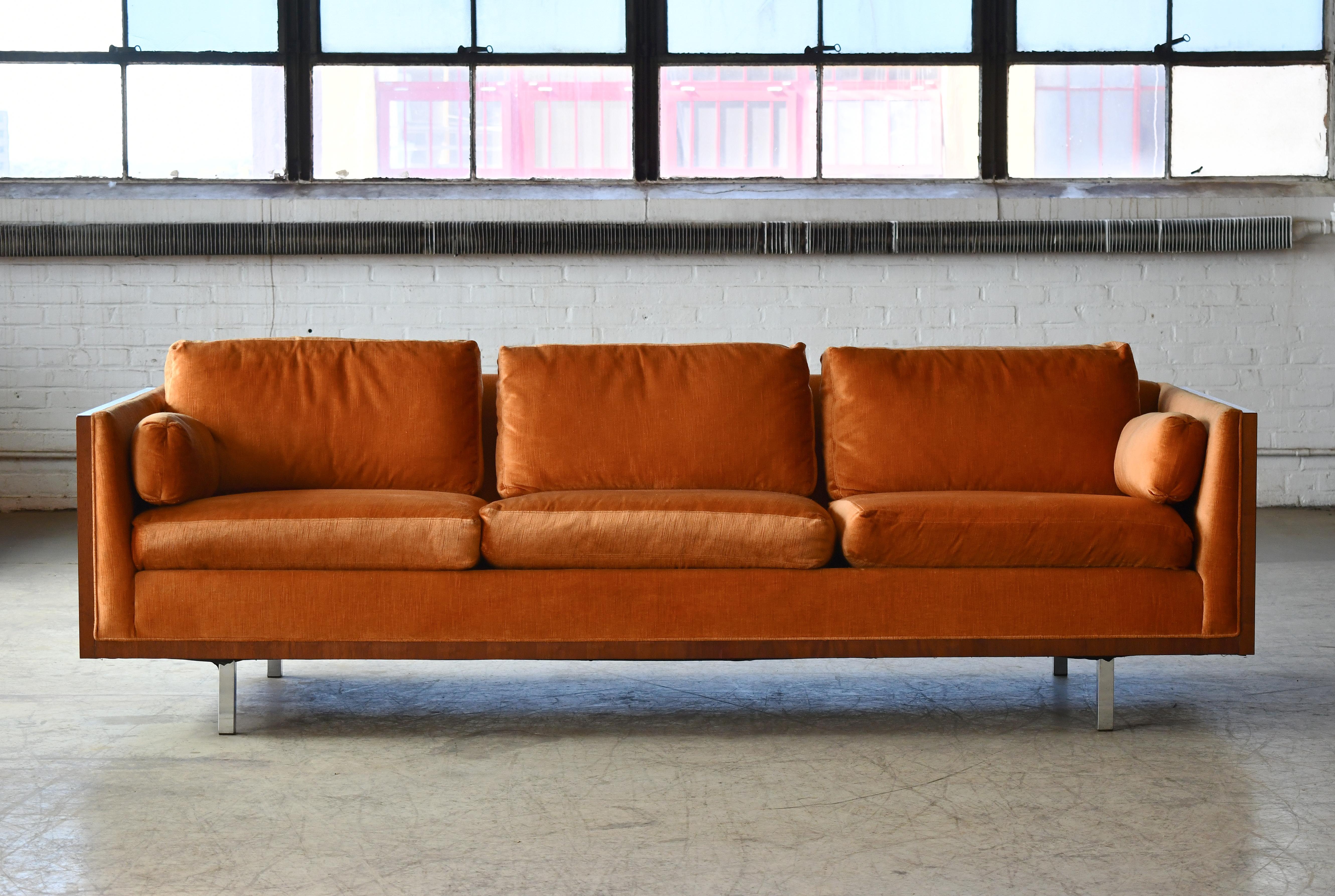 Gorgeous case sofa with figural walnut sides and square chrome legs attributed to Milo Baughman for Thayer-Coggin. The sofa was bought from New York based retailer, Maurice Villency in the late 1970's and carries a label from here. 
Amazing deep
