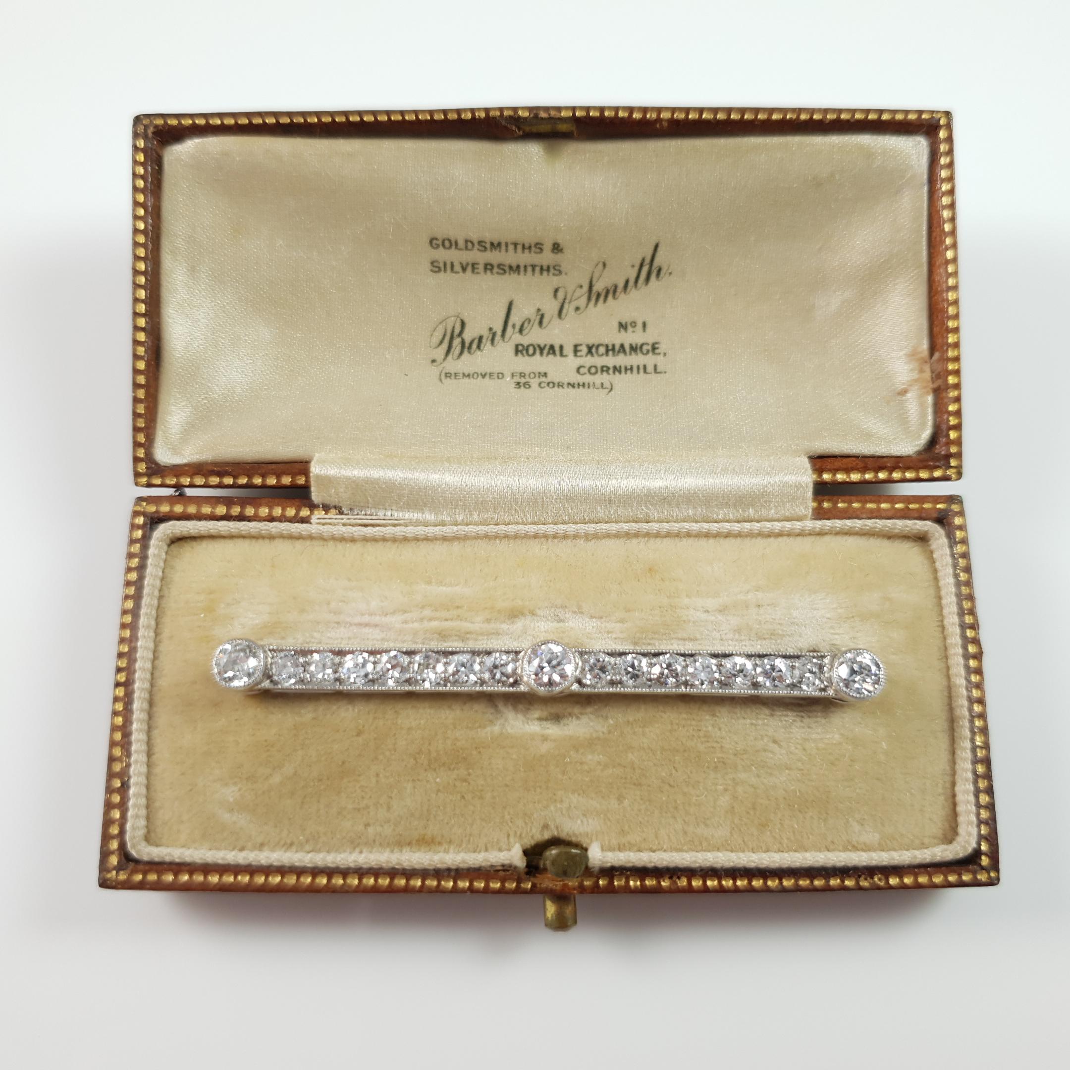 Description: - This is a delightful cased Art Deco period (c1920) platinum & gold diamond bar brooch. The bar brooch is set with seventeen diamonds with good clarity and sparkle totaling approximately 1.72cts. As was common for the period, the