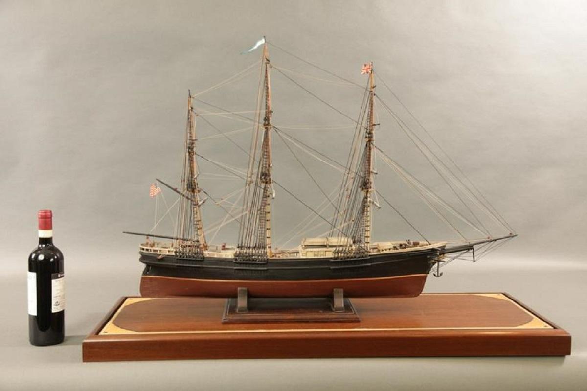Antique model of the American clipper ship Flying Cloud. Model is circa 1930. Details include scribed varnished wood deck, cabins, hatches, skylight, livestock coop, etc. Mounted into a later glass display case with inlaid marquetry.

Overall