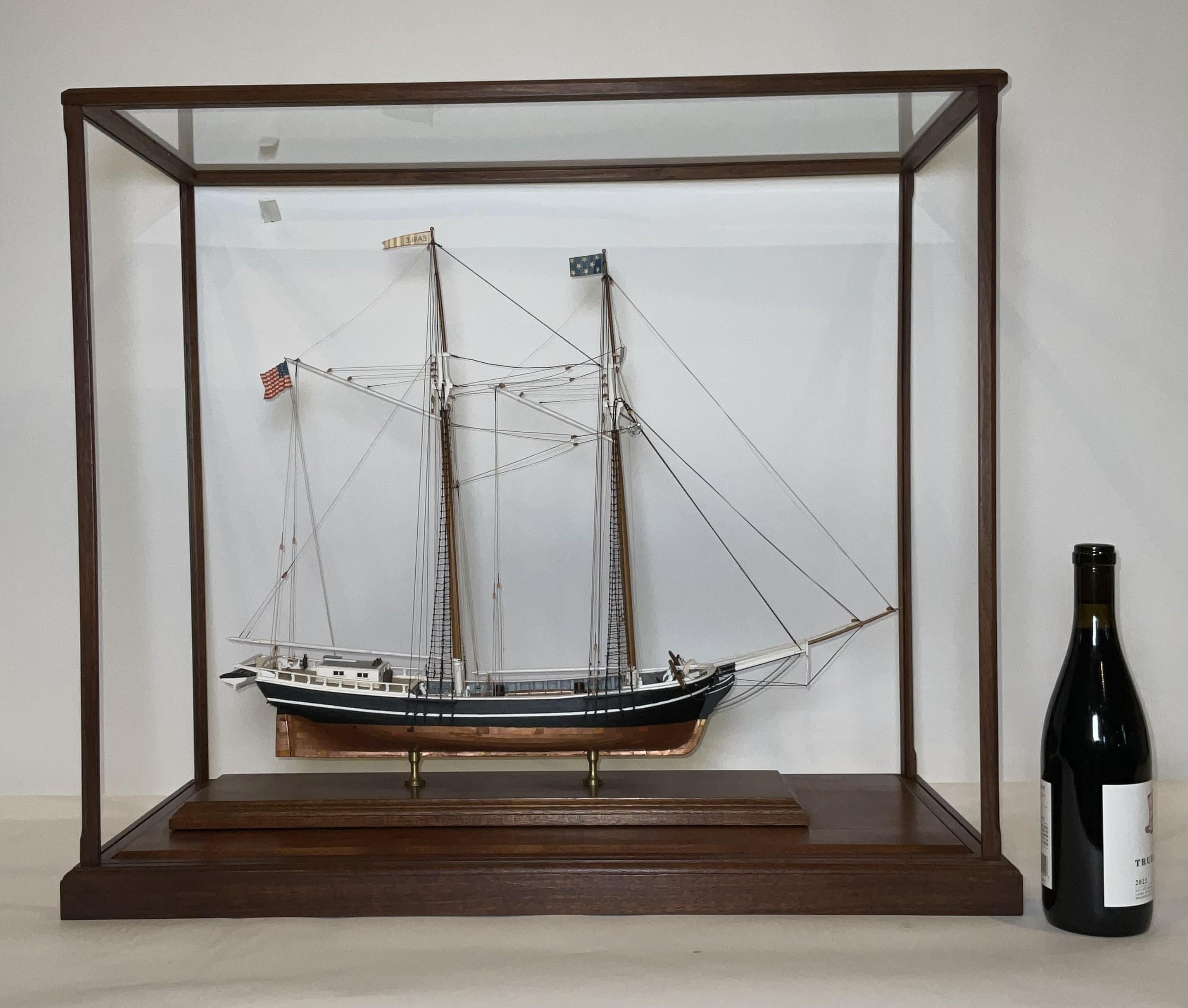 Well-built model of the coastal schooner Eagle with a copper sheathed hull, scribed deck, cabins, hatches, flags, barrels, etc. The Eagle was from Bath, Maine. Fitted to a custom display case.

Weight:    32 lbs.
Overall Dimensions:    27
