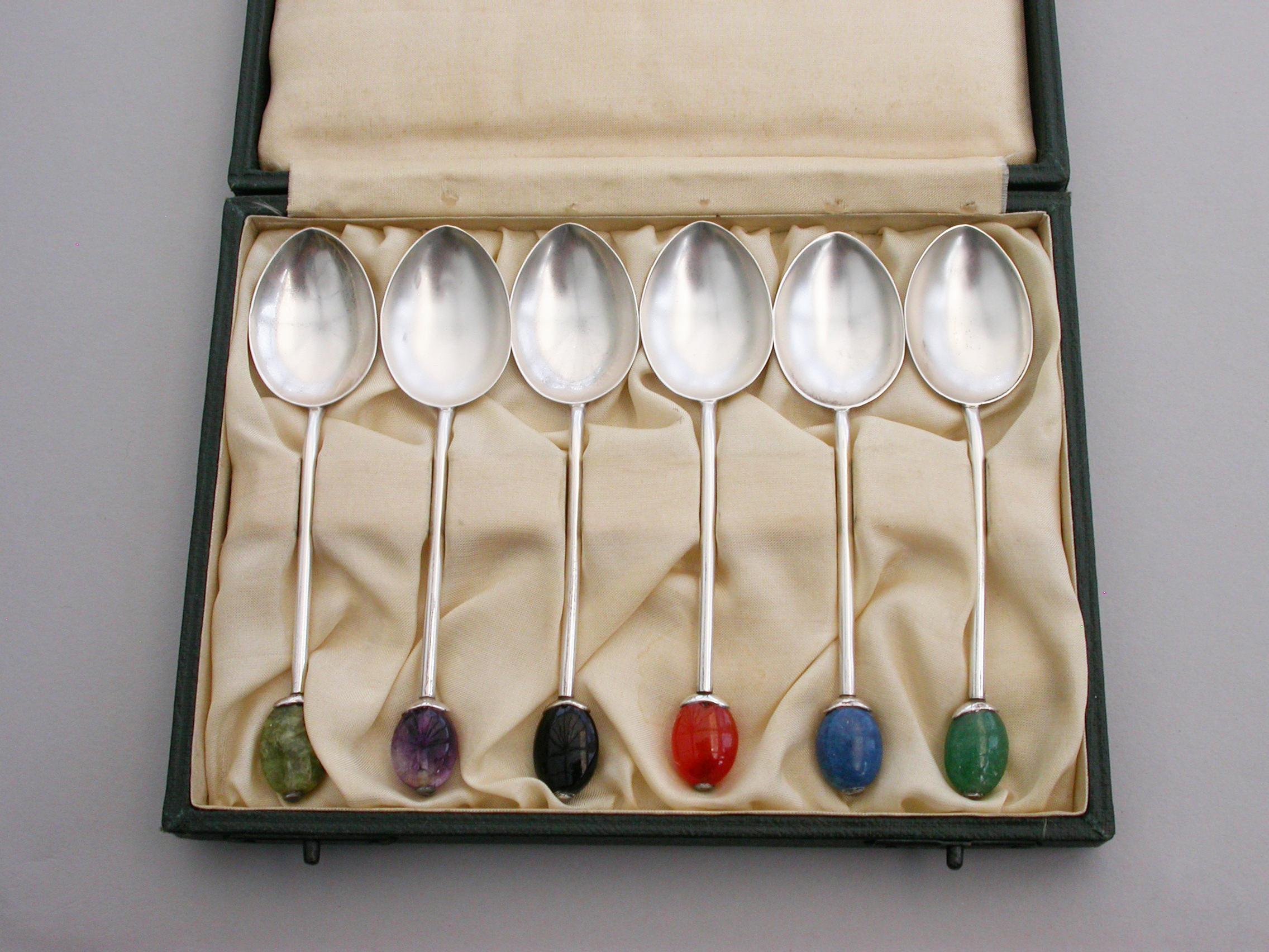 A good set of six cased silver coffee spoons, the terminals modelled as coffee beans from various different colored hardstones. Complete with original fitted retailer's case.

By Liberty & Co, Birmingham, 1927-1928.

40 grams total weight of