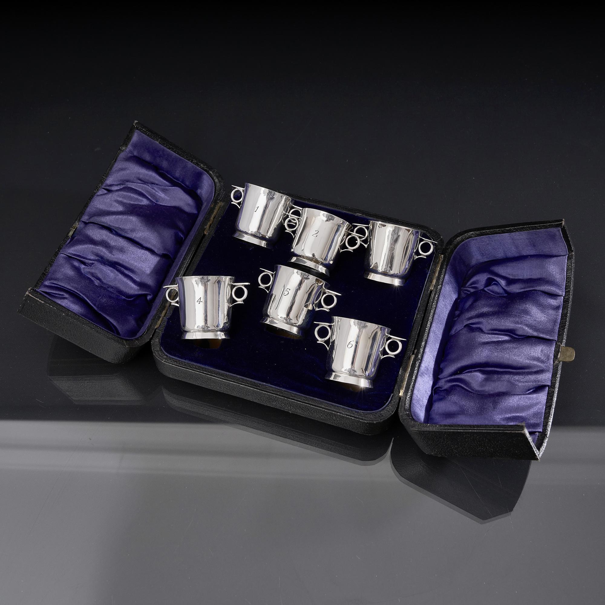 Set of six antique American silver whiskey tots created in the form of two-handled wine coolers.  Numbered from one to six, these charming presented in their original presentation case. Each tot is numbered.

A tot of whiskey is an informal measure
