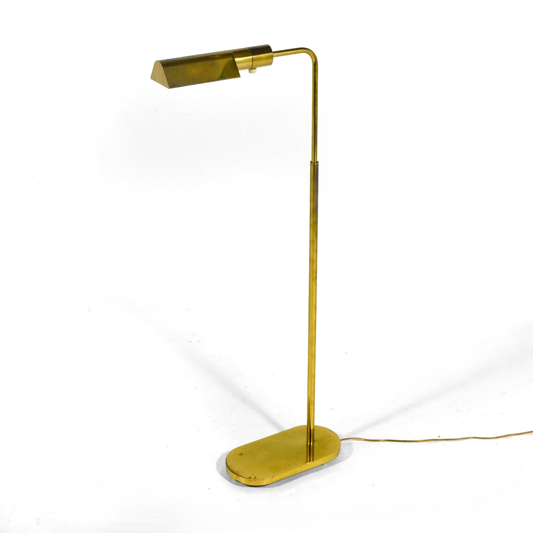 This wonderful pharmacy floor lamp designed by Jon Norman for Casella is impeccably constructed of solid brass. The heavy oval base is raised on nylon feet for a subtle reveal and supports and adjustable neck that’s topped with a classic triangular