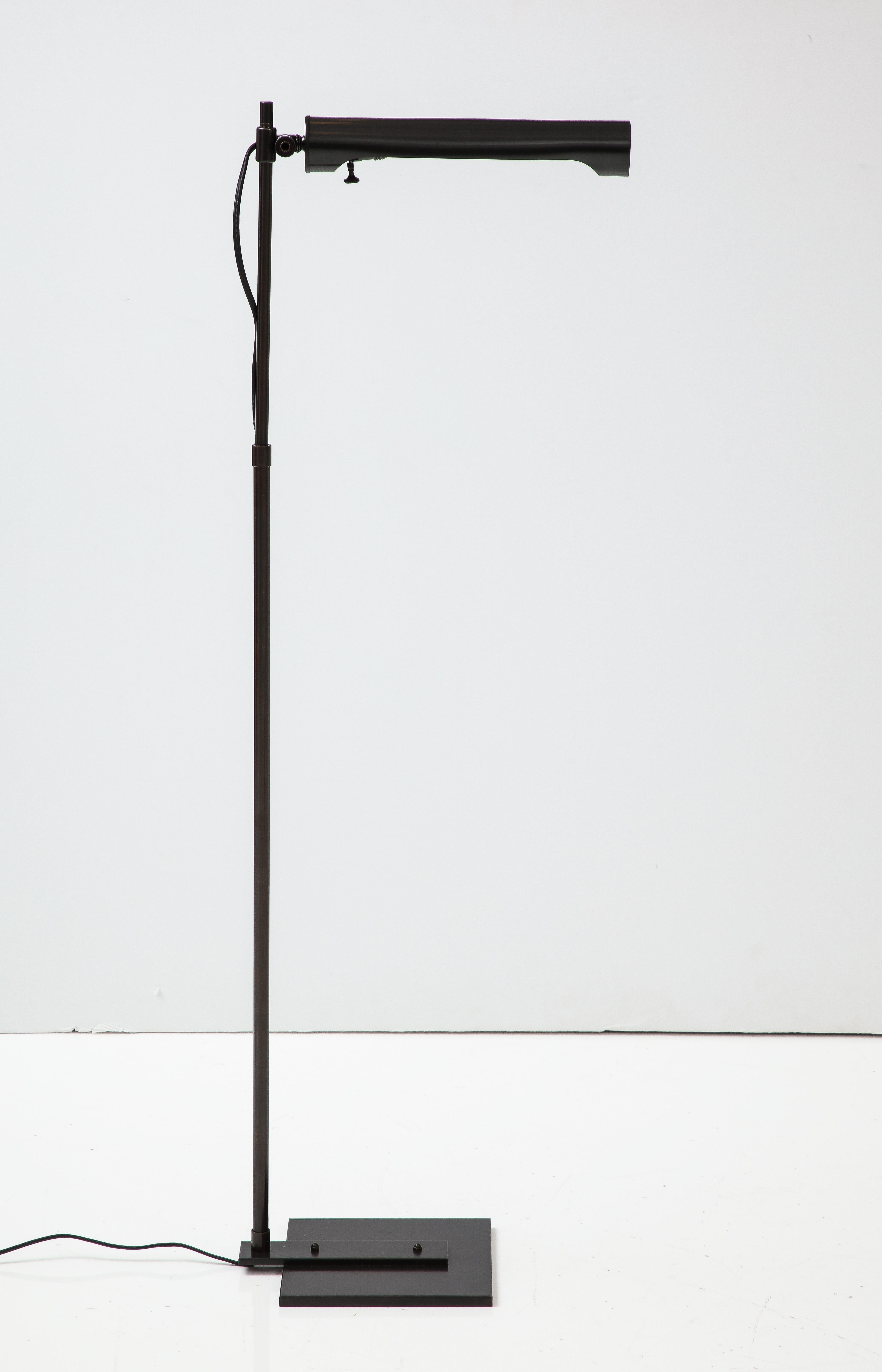 Architectural adjustable dark bronze floor lamp featuring a tubular shade and square base. Rewired for use in the USA using black silk cord.
