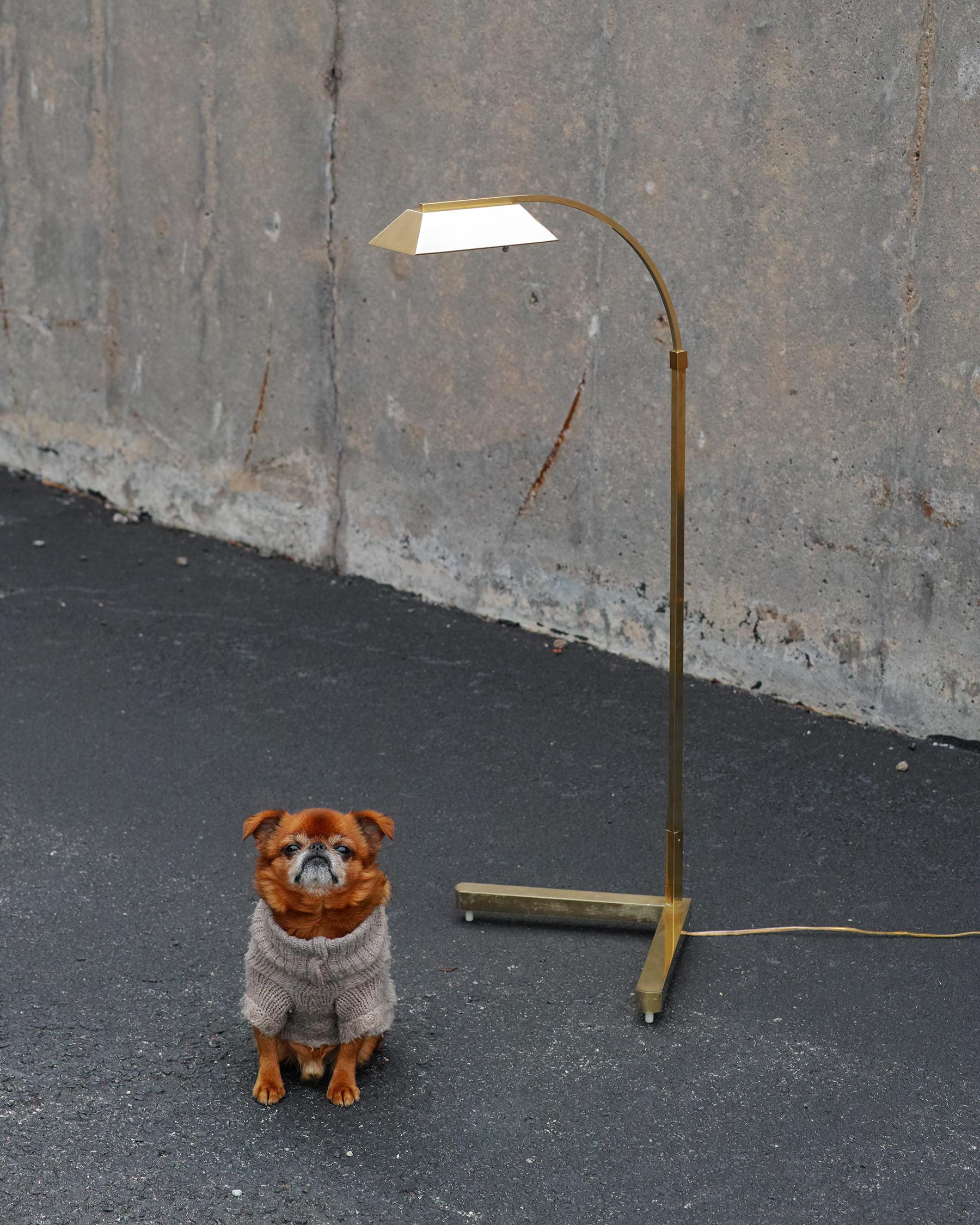 For your consideration is this elegant, brass floor lamp by Casella featuring a slim, weighted v-form base elevated on its original plastic feet; variable height of 38