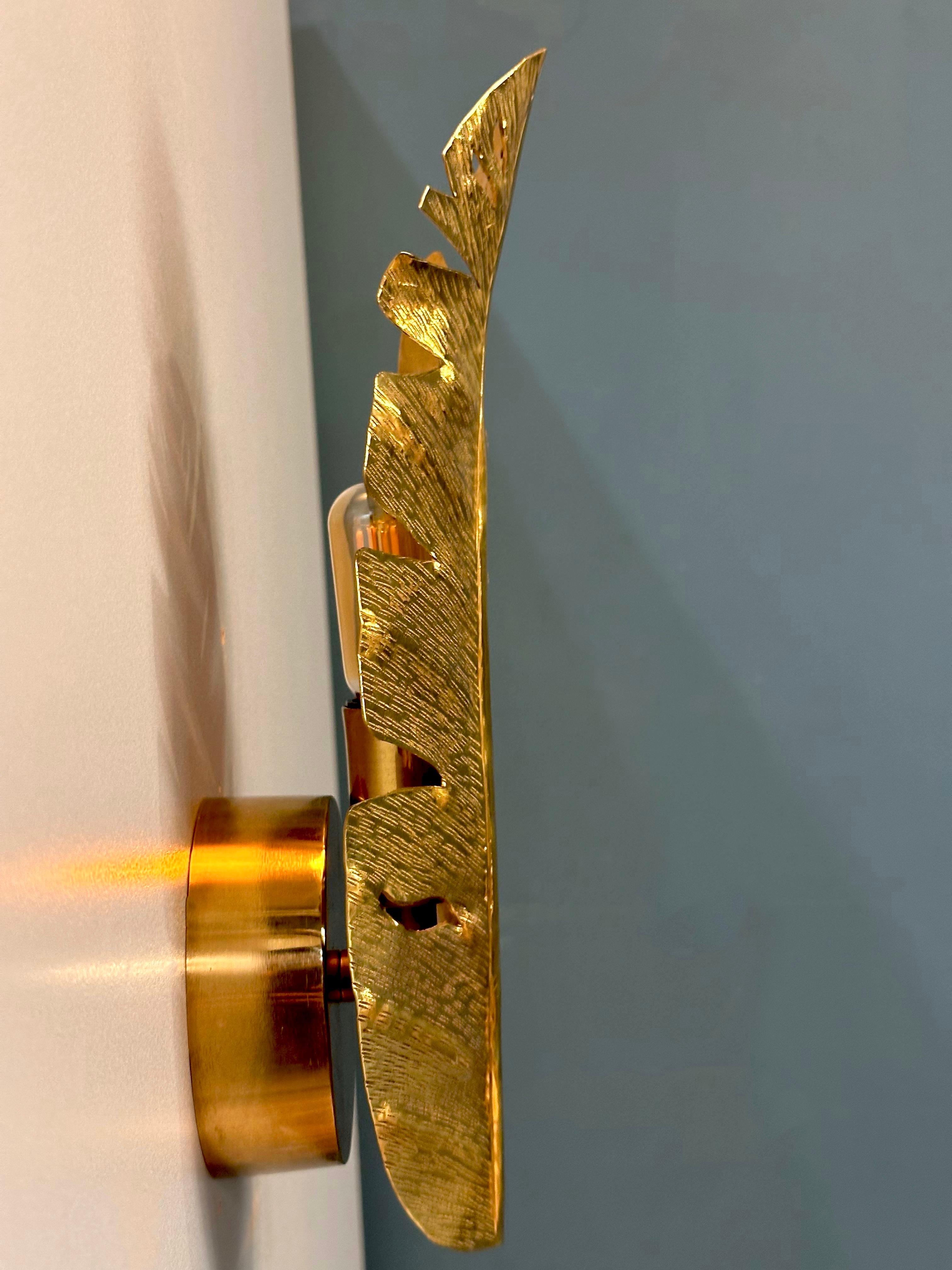 CASERTA Brass Wall Sconce, where artistry meets functionality in a symphony of brass craftsmanship. This unique wall sconce not only provides enchanting illumination but also serves as a captivating tribute to nature, meticulously bringing the