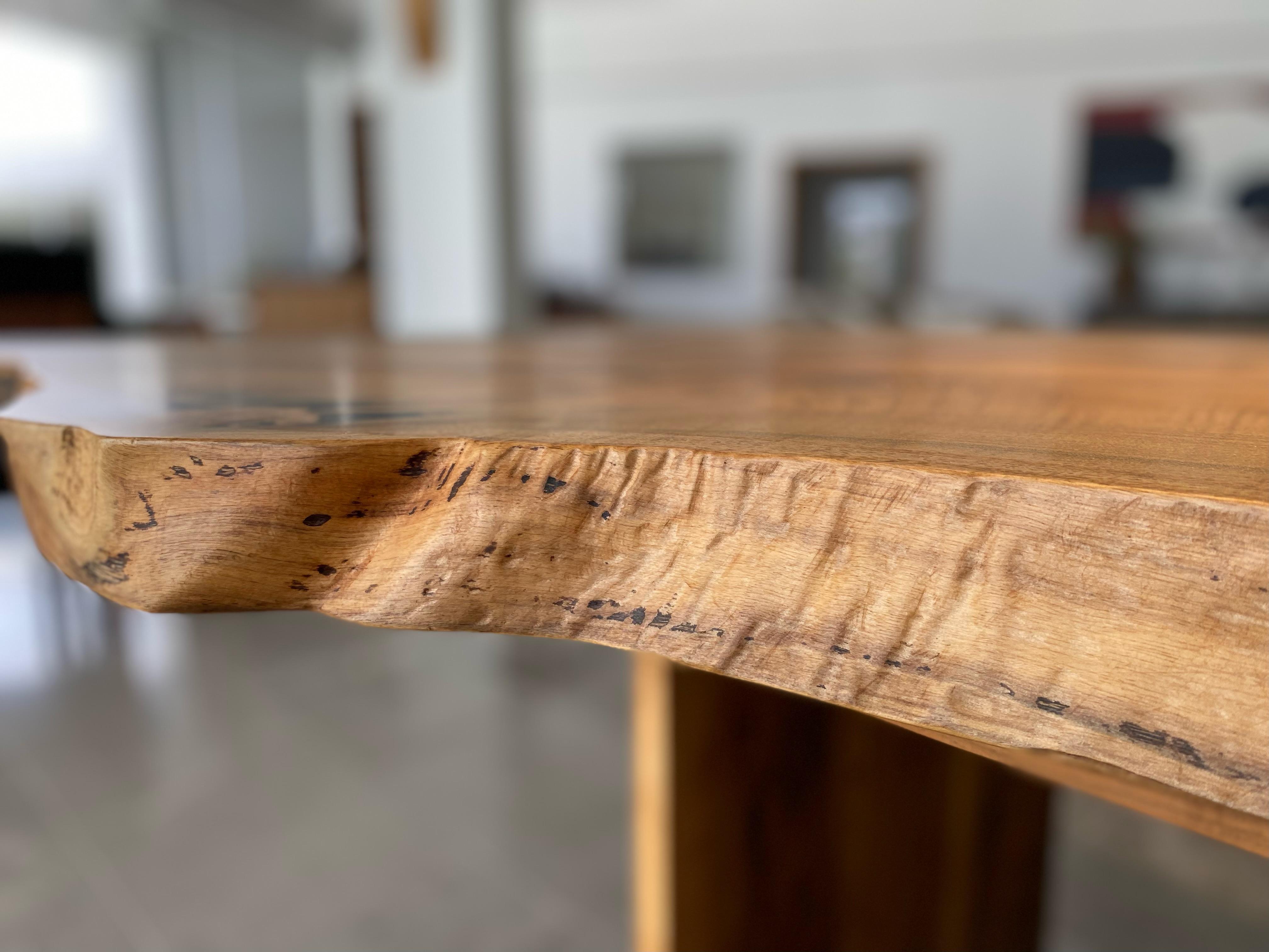 Casey McCafferty walnut slab dining table with brass butterfly joints with waxed and sealed finish . One end is 42.5