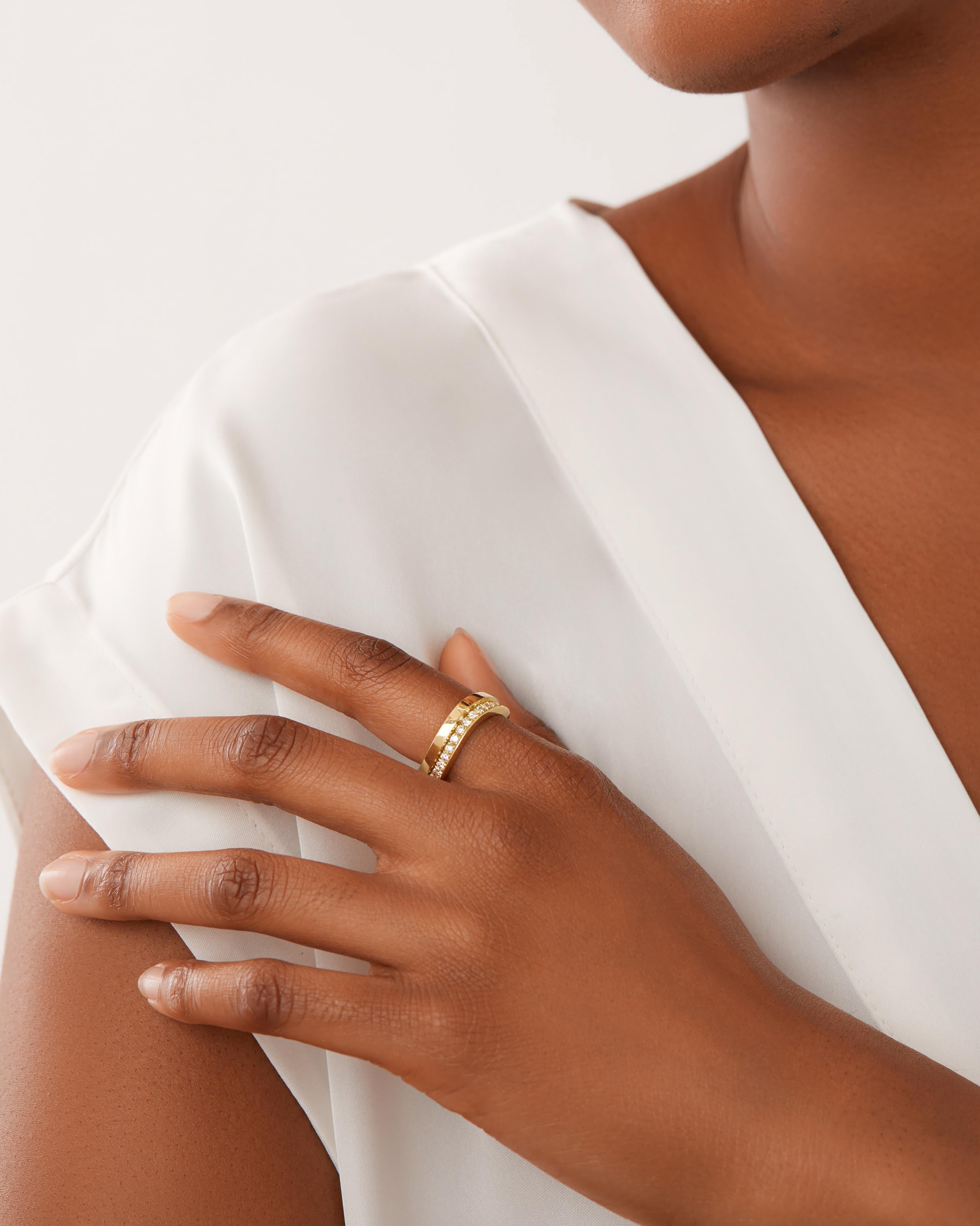 This 18K yellow gold ring features a modern tiered detail set with brilliant cut diamonds all the way around the band. Wear it alone or as multiples, the ring is designed to stack perfectly.