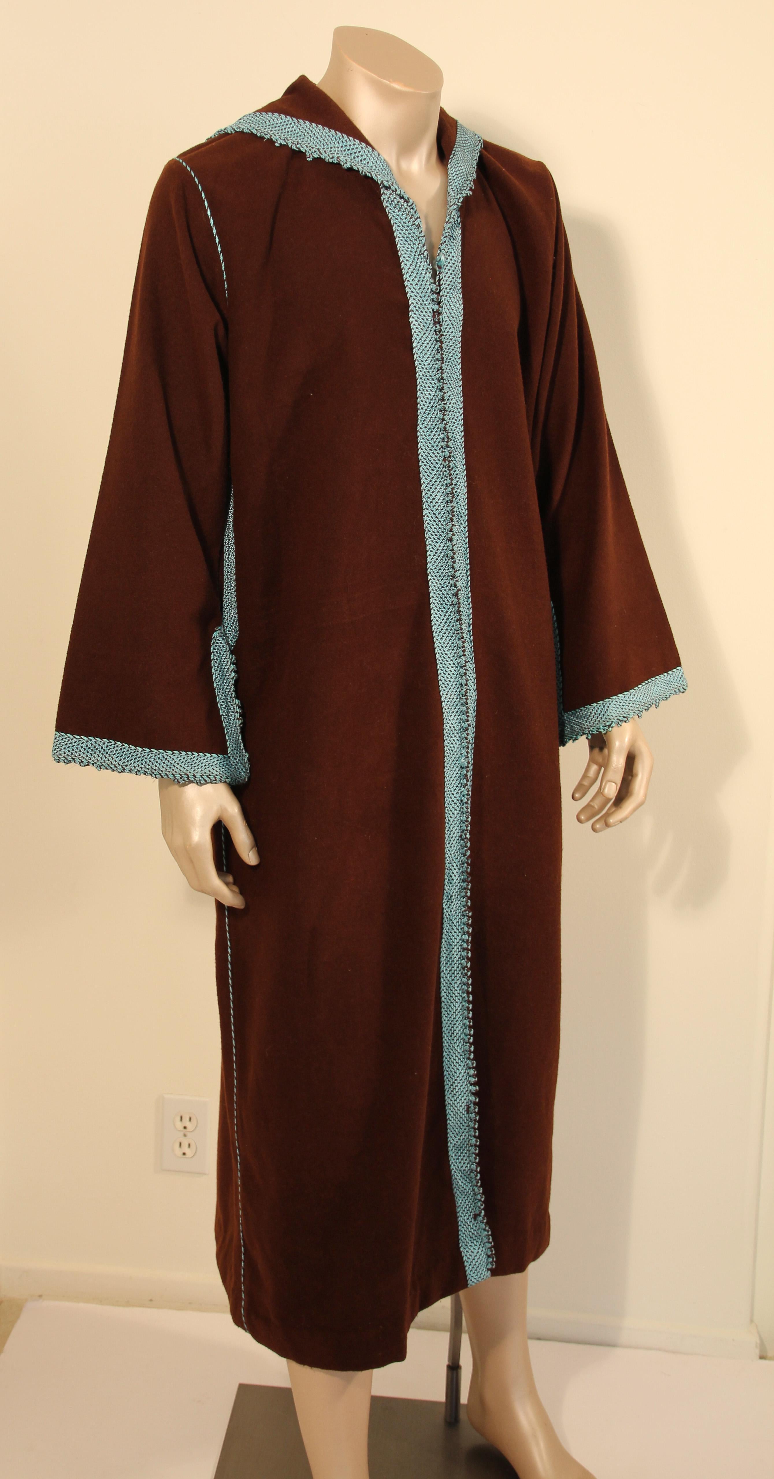 Handmade Moroccan cashmere brown and turquoise long maxi dress caftan from North Africa, Morocco.
Vintage 1980s caftan coat.
Caftan with running down the center round braided buttons from the neckline to the hemline.
Fully front thread buttoning