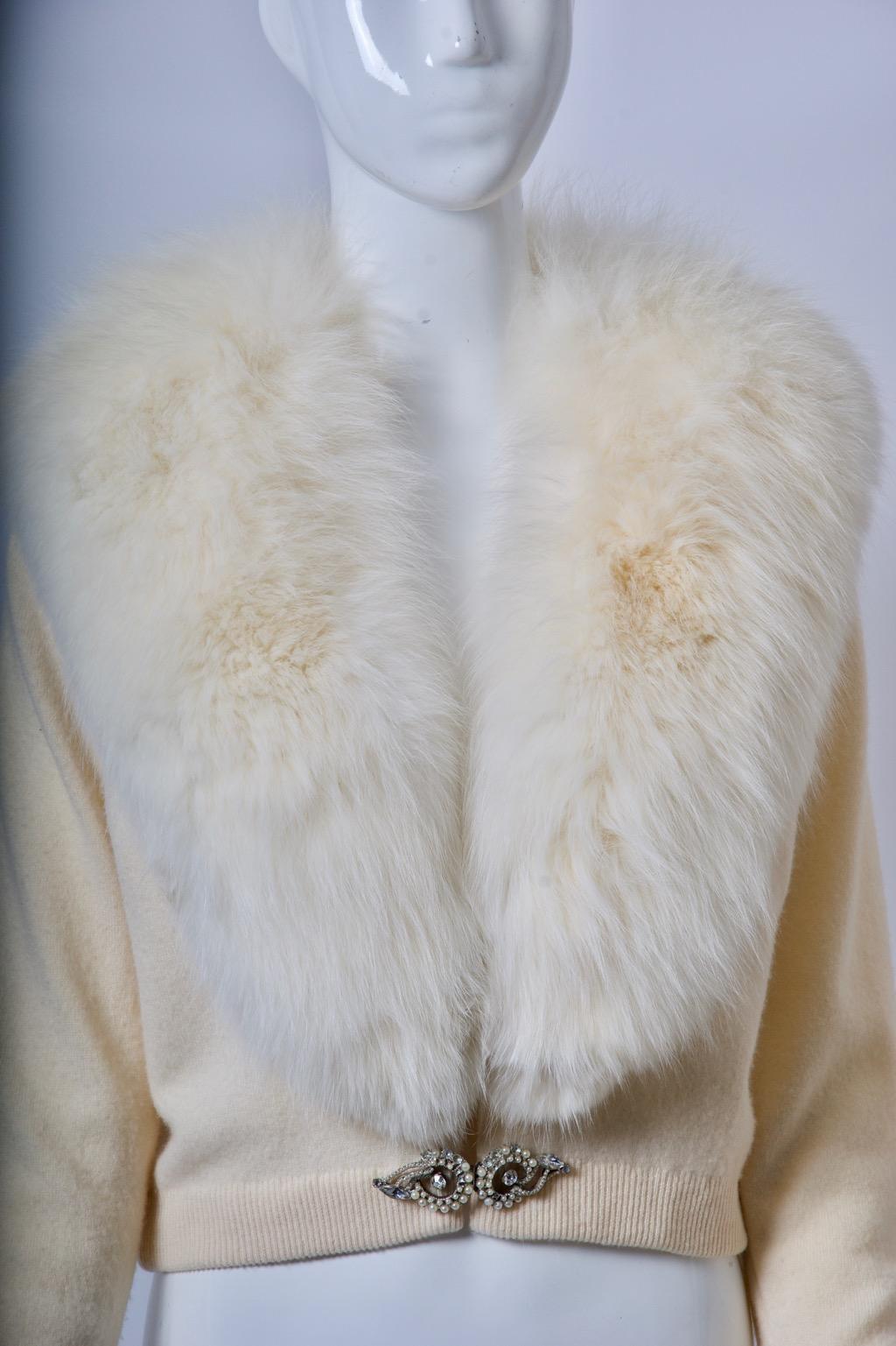 Among my favorite vintage items are the embellished cardigans from the 1950s-'60s, many of them with fur collars. This example, rare for its excellent condition, is made of ivory cashmere with a lush white fox collar, which is connected with snaps