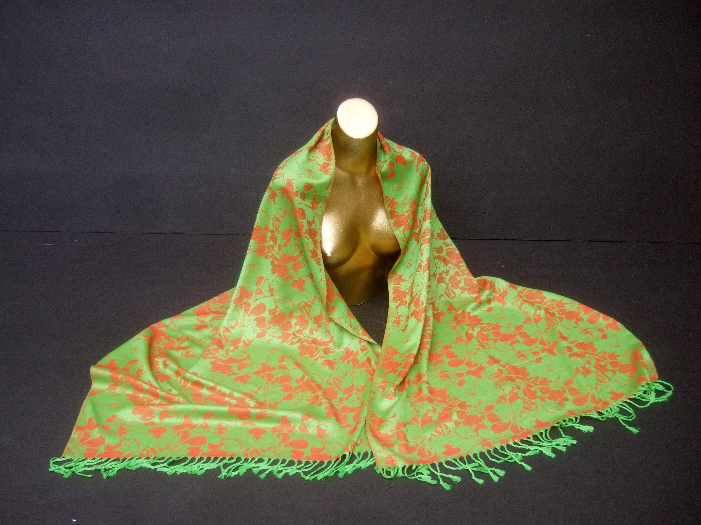 Luxurious cashmere floral print fringe shawl-wrap 74 in x 27 in 
The elegant cashmere shawl wrap is infused with copper-tone color
flower pedals; juxtaposed with a chartreuse apple-green 
background

The versatile textile may be draped over the body