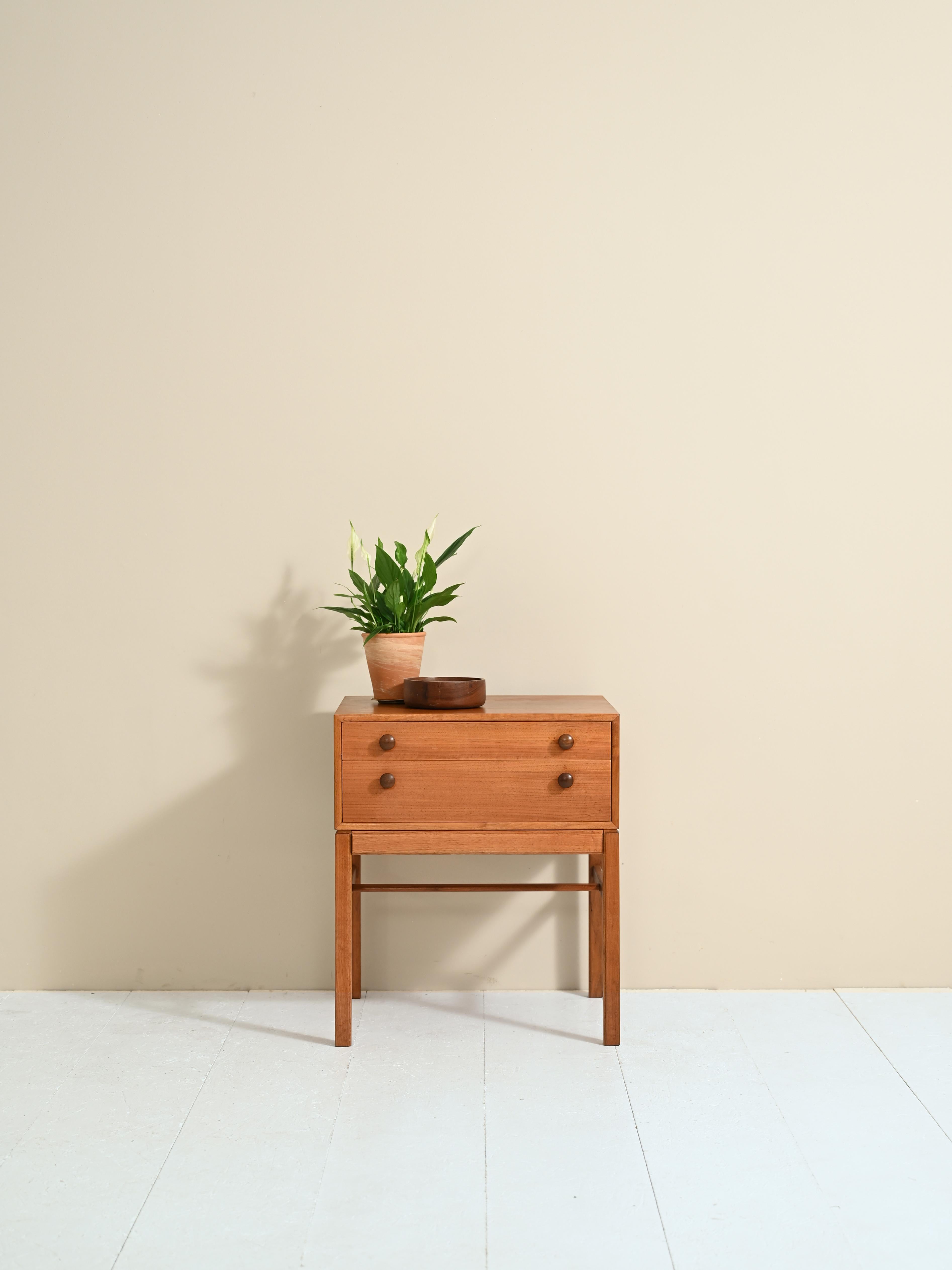 Two-drawer cabinet designed by Engstrom Myrland as reported by the stamp of authenticity.

Square lines and attention to detail are the hallmarks of this Scandinavian-made furniture piece.
A versatile piece of furniture that, thanks to its shape