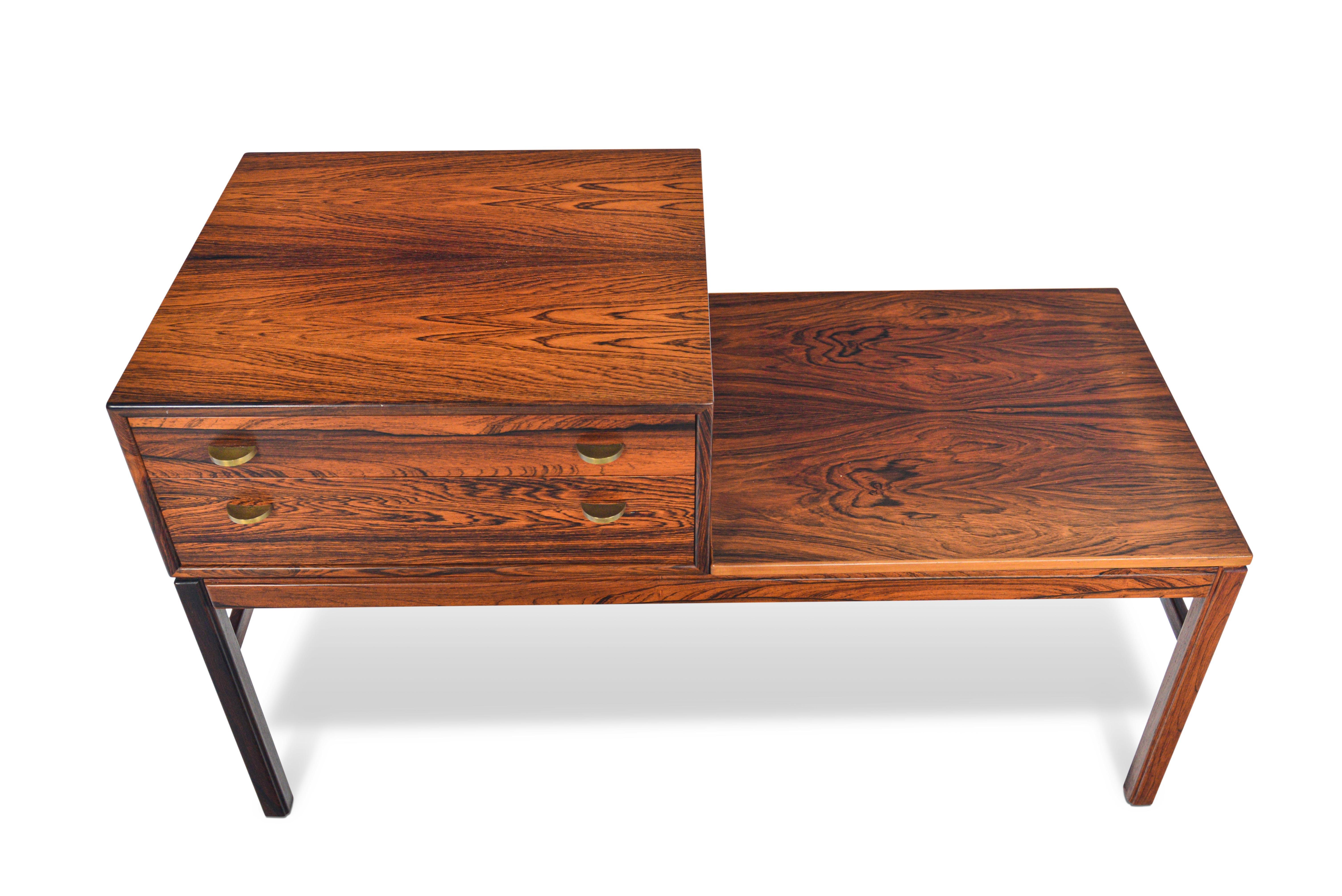This exceptional Swedish modern “Casino” model telephone bench in Brazilian rosewood was designed by Sven Engström & Gunnar Myrstrand for Tingströms, Bra Bohag in the 1960s. This large bench offers a removable case with a two drawers with brass