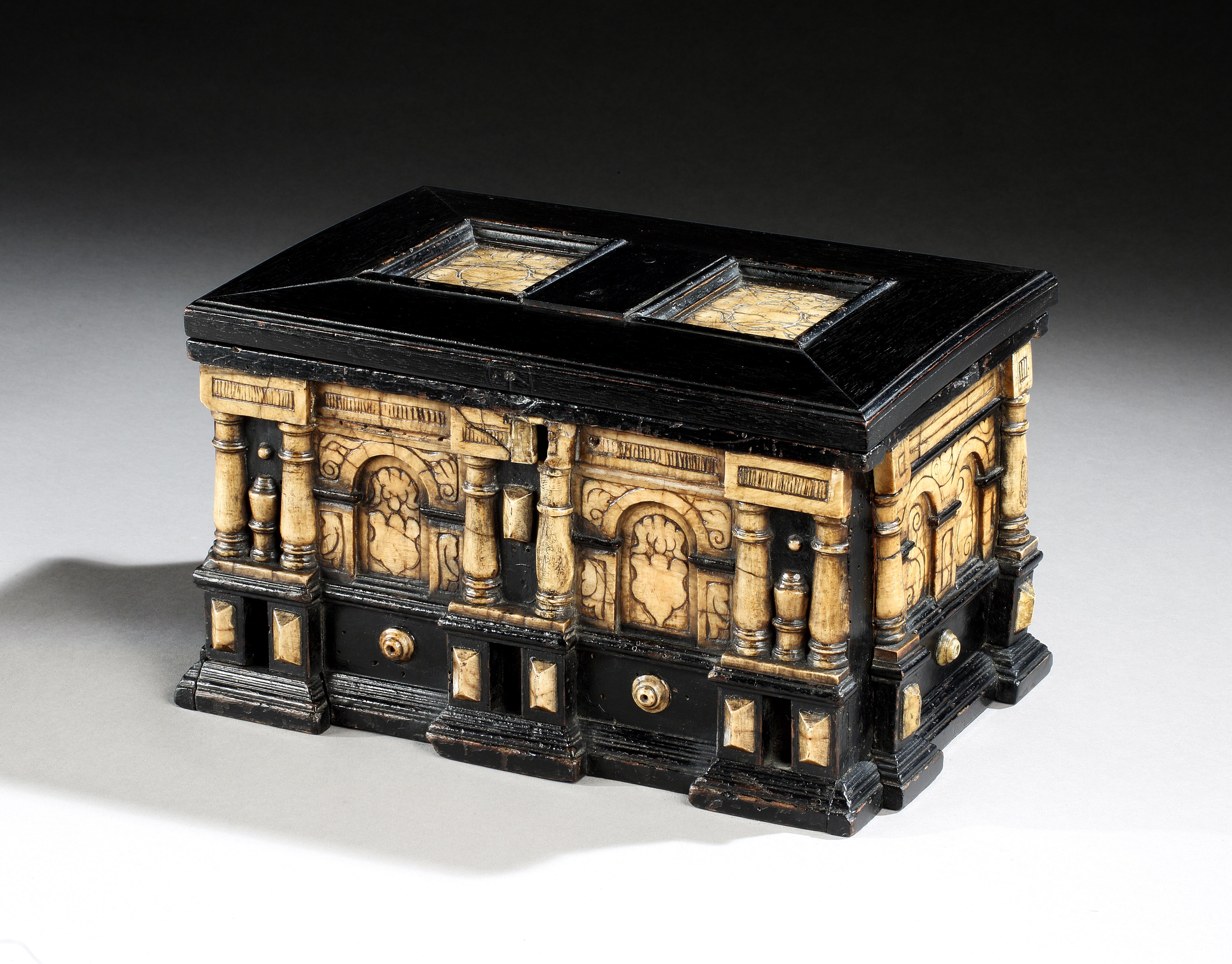 An early 17th century, Flemish, Malines, ebonized and alabaster cabinet with removable sliding sides revealing secret drawers 12” long.

The ebonized top with two carved alabaster panels within ogee mouldings and a mitred frame. The architectural