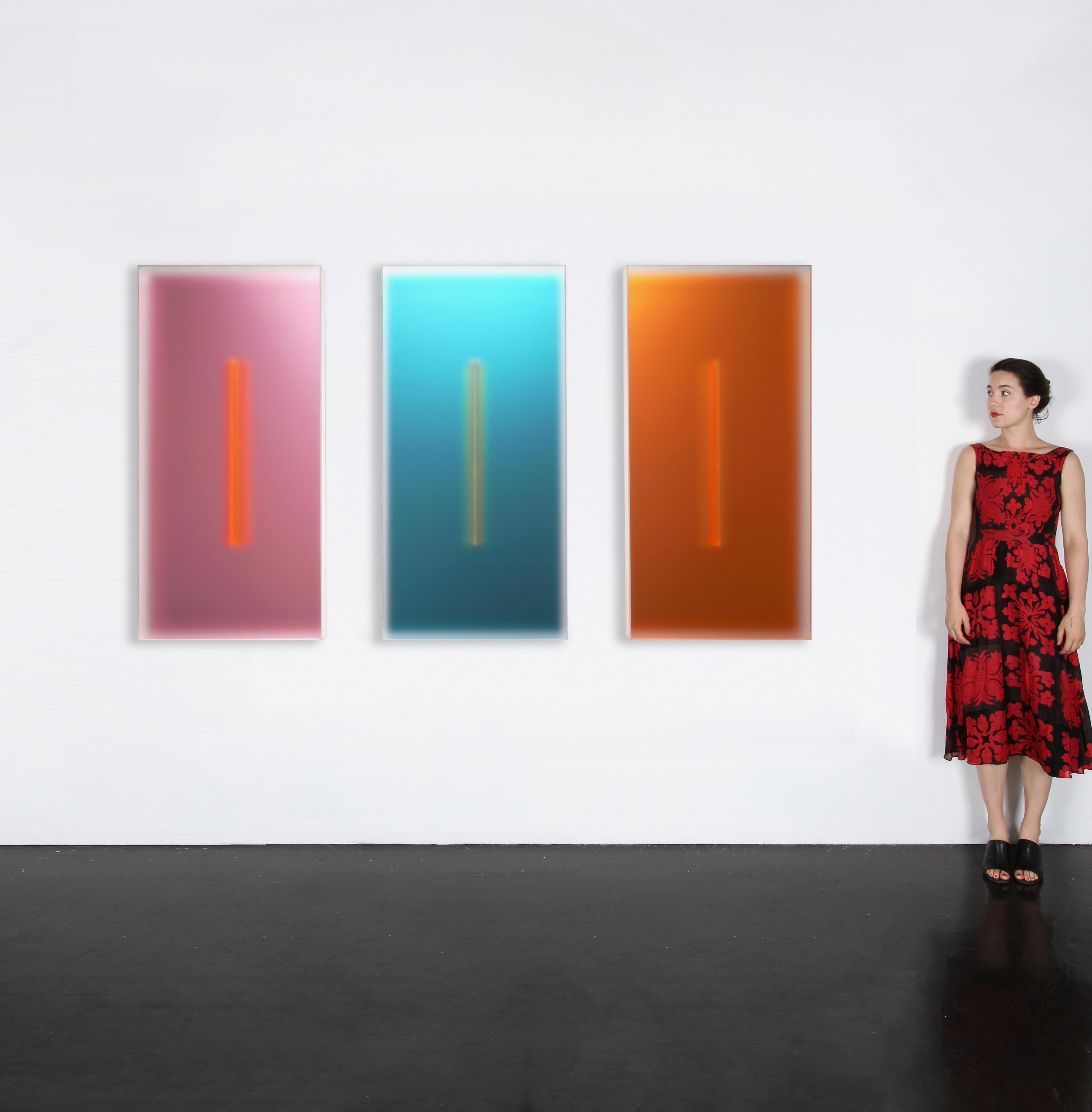 In der ersten seiner neuesten Serie, Light-Glyphs, beleuchtet eine Reihe von Farben das Innere von durchscheinenden skulpturalen Kästen. Das Licht diffundiert durch ihre matten Oberflächen und macht die Farben im Inneren weich. In der Mitte fängt