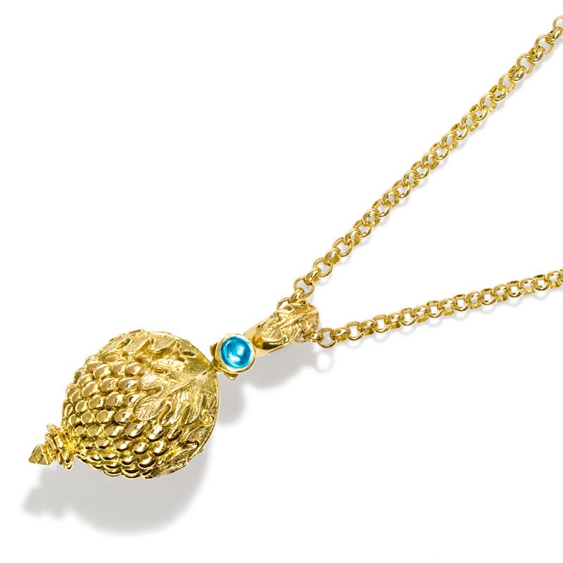 Inspired by the charms on an Indian marriage necklace (known as a Thali) in the Victoria and Albert museum from Madras, India. 

The pendant measures approximately 58mm in length including the loop and is made from 9ct yellow gold set with blue