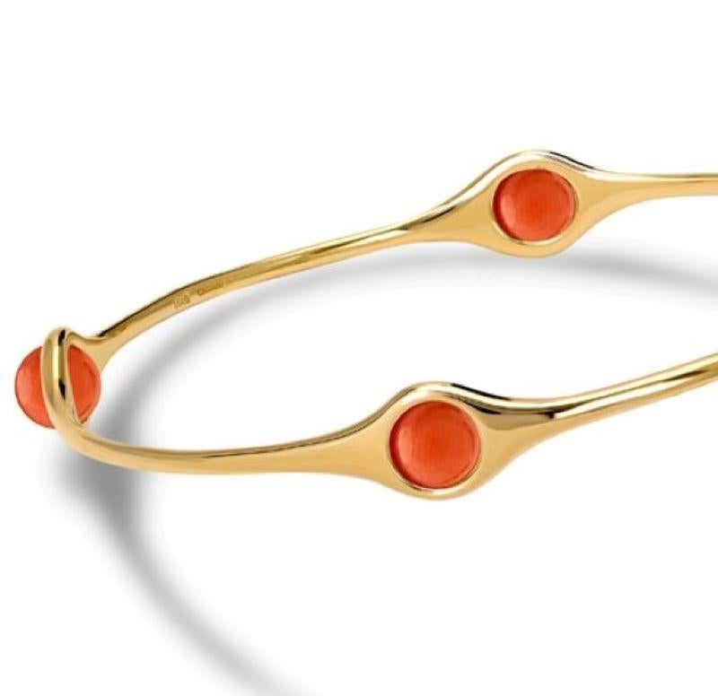 Persephone bangle in 9ct yellow gold set with four coral beads. Inspired by the story of the Greek goddess Persephone who was so tempted by pomegranate seeds... From the Journey to Sicily.