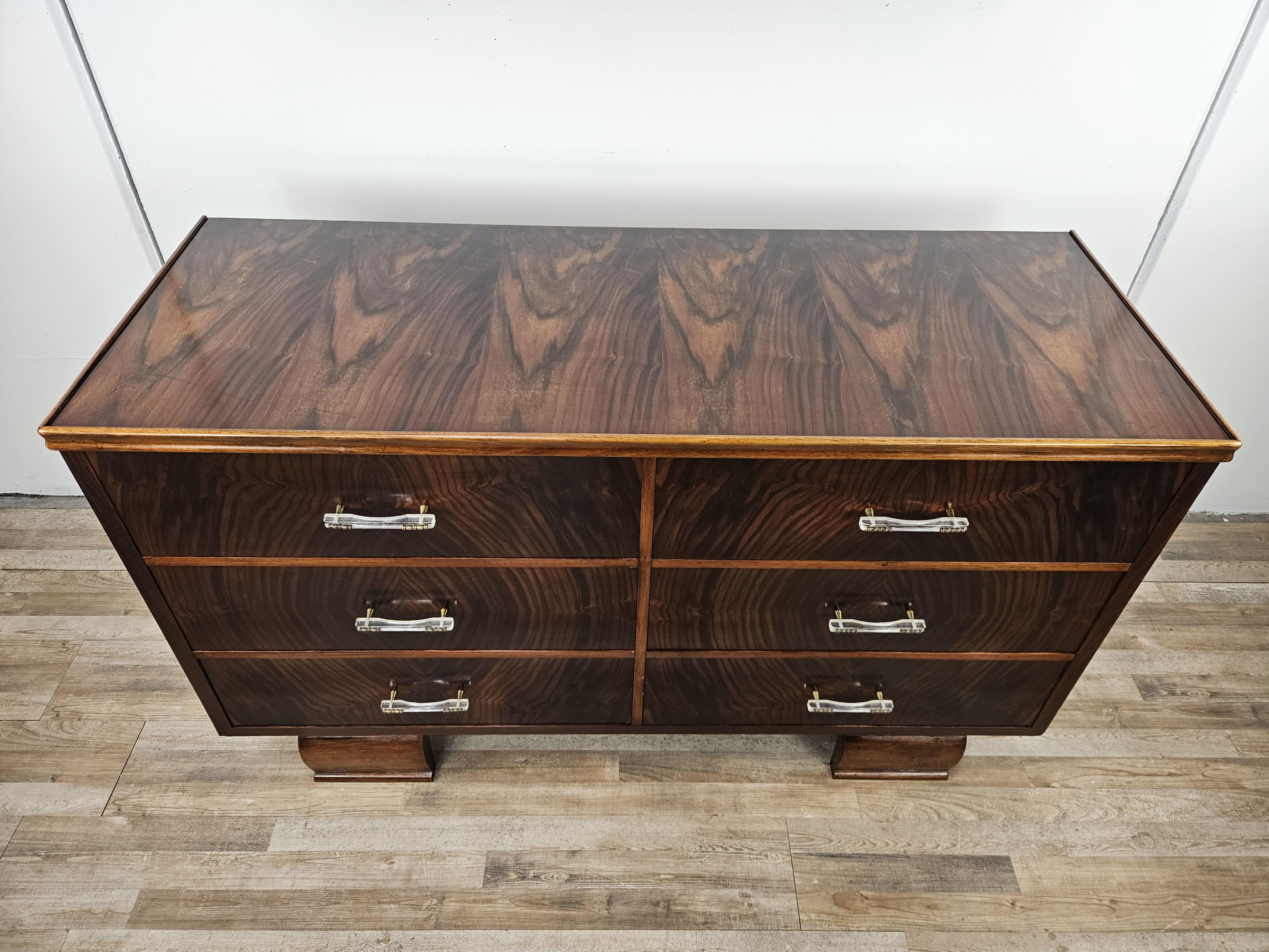Elegant 1940s chest of drawers in Italian Art Deco style, embellished with a distinctive set of clear plastic and brass handles.

It has six large and roomy internally lined drawers, and can be used as a bedroom dresser or as a chest of drawers in