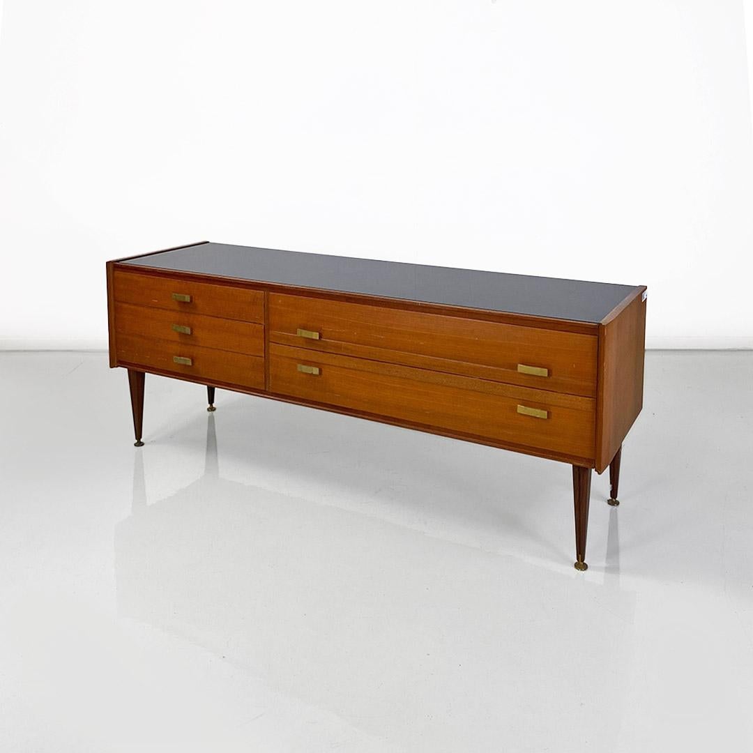 Italian chest of drawers, wood, glass and brass details, Vittorio Dassi, 1950s
Wood-framed chest of drawers or sideboard with beveled profiles and asymmetrically arranged drawers, of which three smaller ones are on the left and two wider ones placed