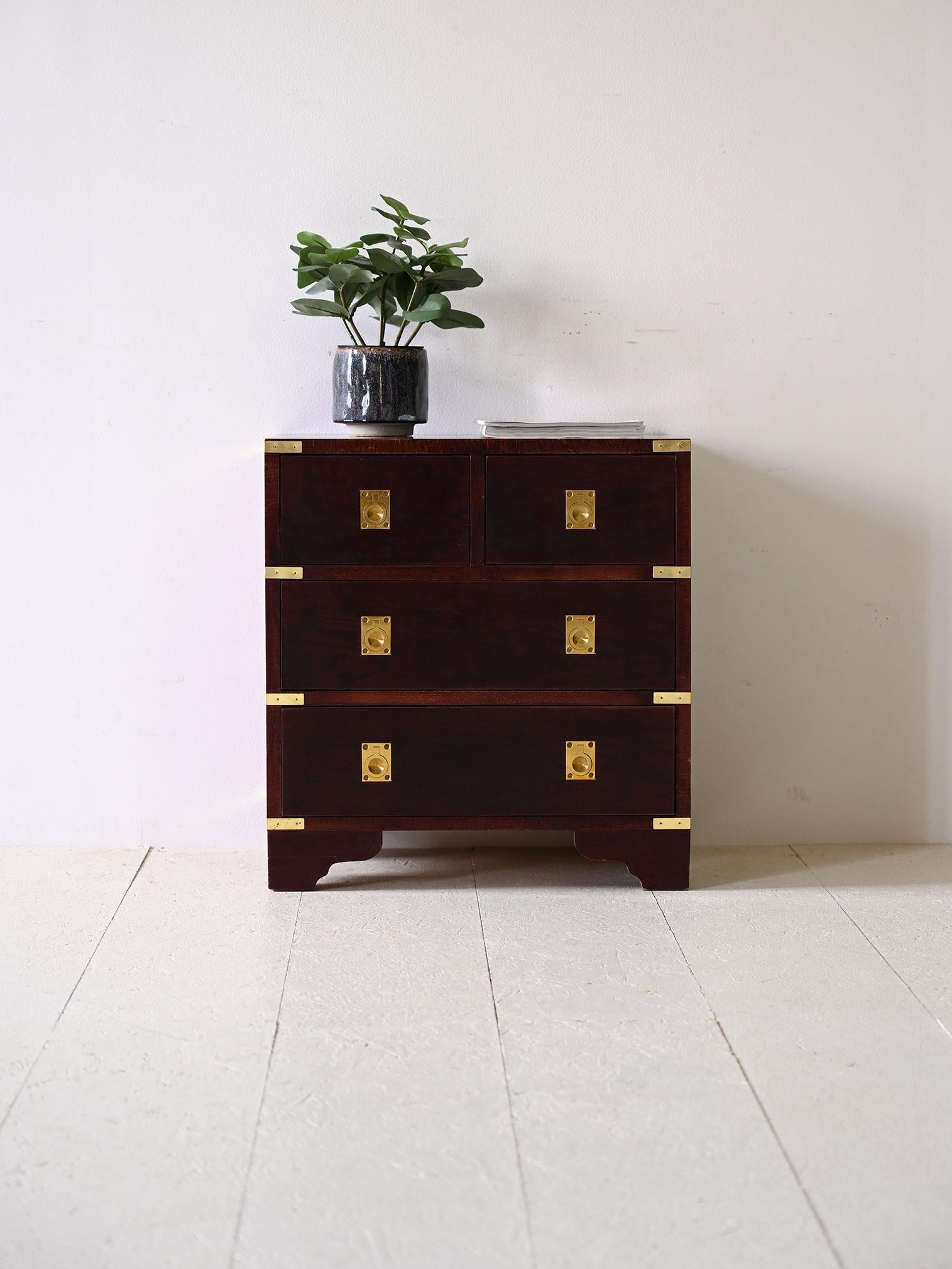 Original vintage Scandinavian chest of drawers.

A Nordic-style mahogany chest of drawers with gilded metal handles with elegant, subtle grooves inward. 

With a simple, square frame, this vintage Scandinavian chest of drawers features two small top