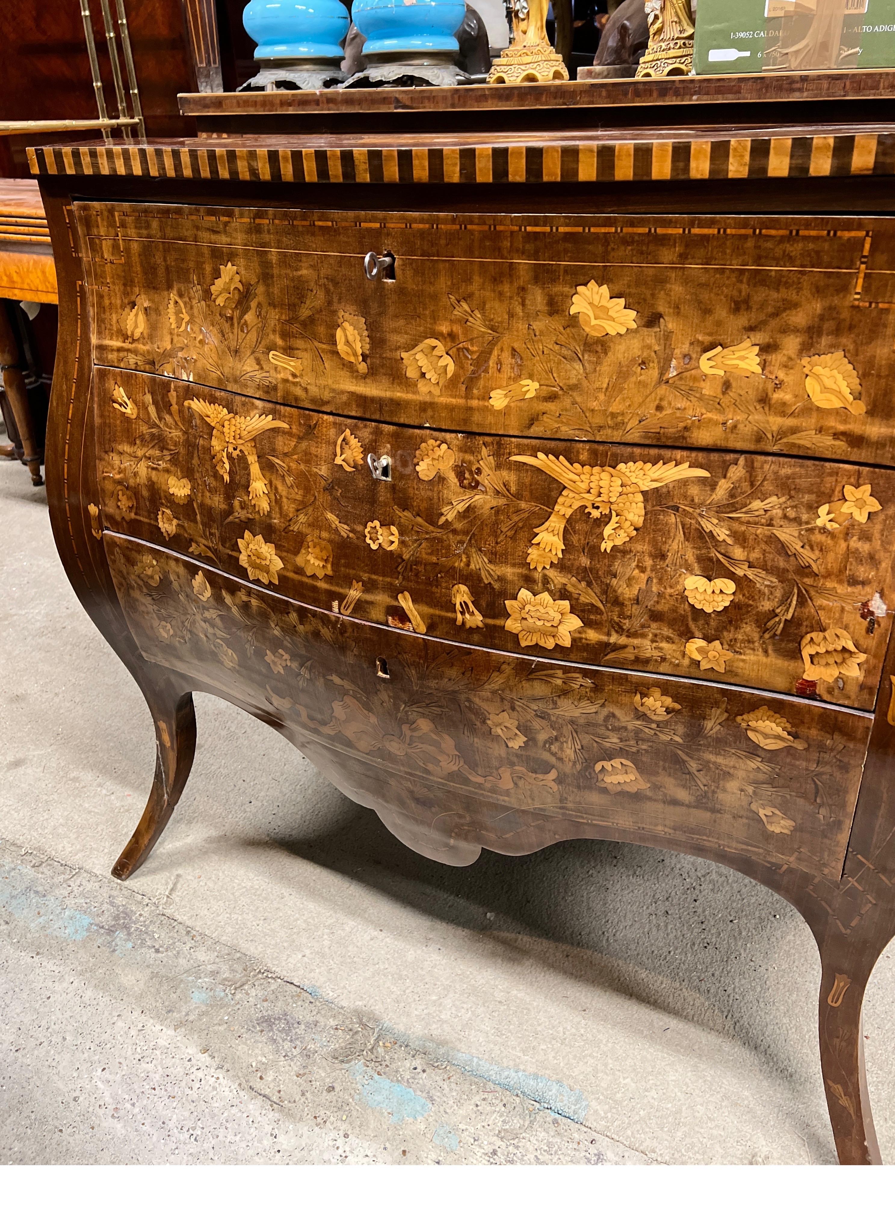 Rare Dutch chest of drawers of convex shape, embellished with floral and bird motif inlays. Moved legs and two front curved drawers. Made of mahogany wood and fruitwood inlays, early 19th century era on the forms and style of the Louis XV period.
