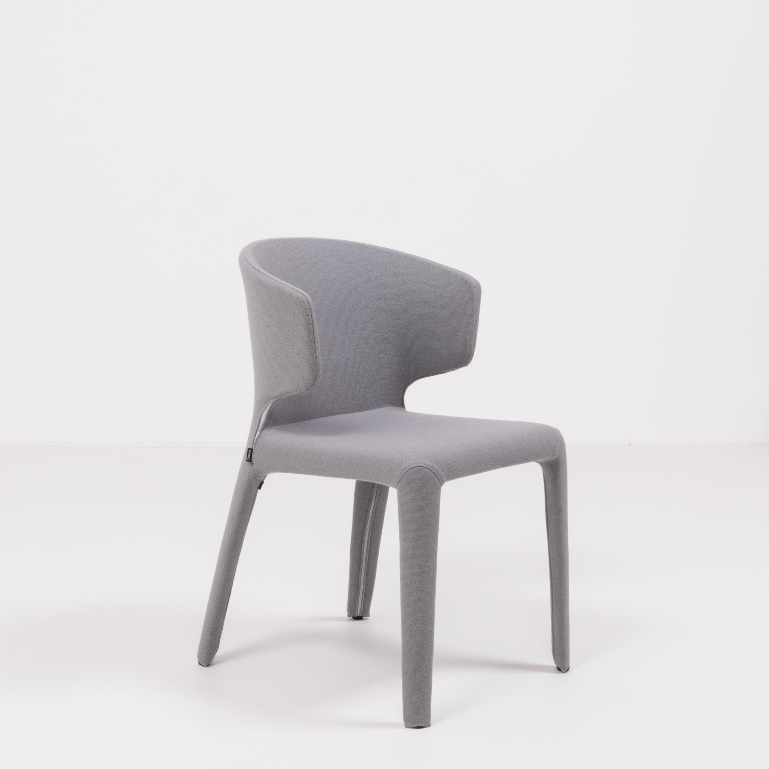 Designed by Hannes Wettstein for Cassina in 2003, these 367 hola dining chairs have a sleek, contemporary silhouette.
 
The set of eight chairs are in excellent, nearly new condition and are fully upholstered in grey wool with zips that allow the