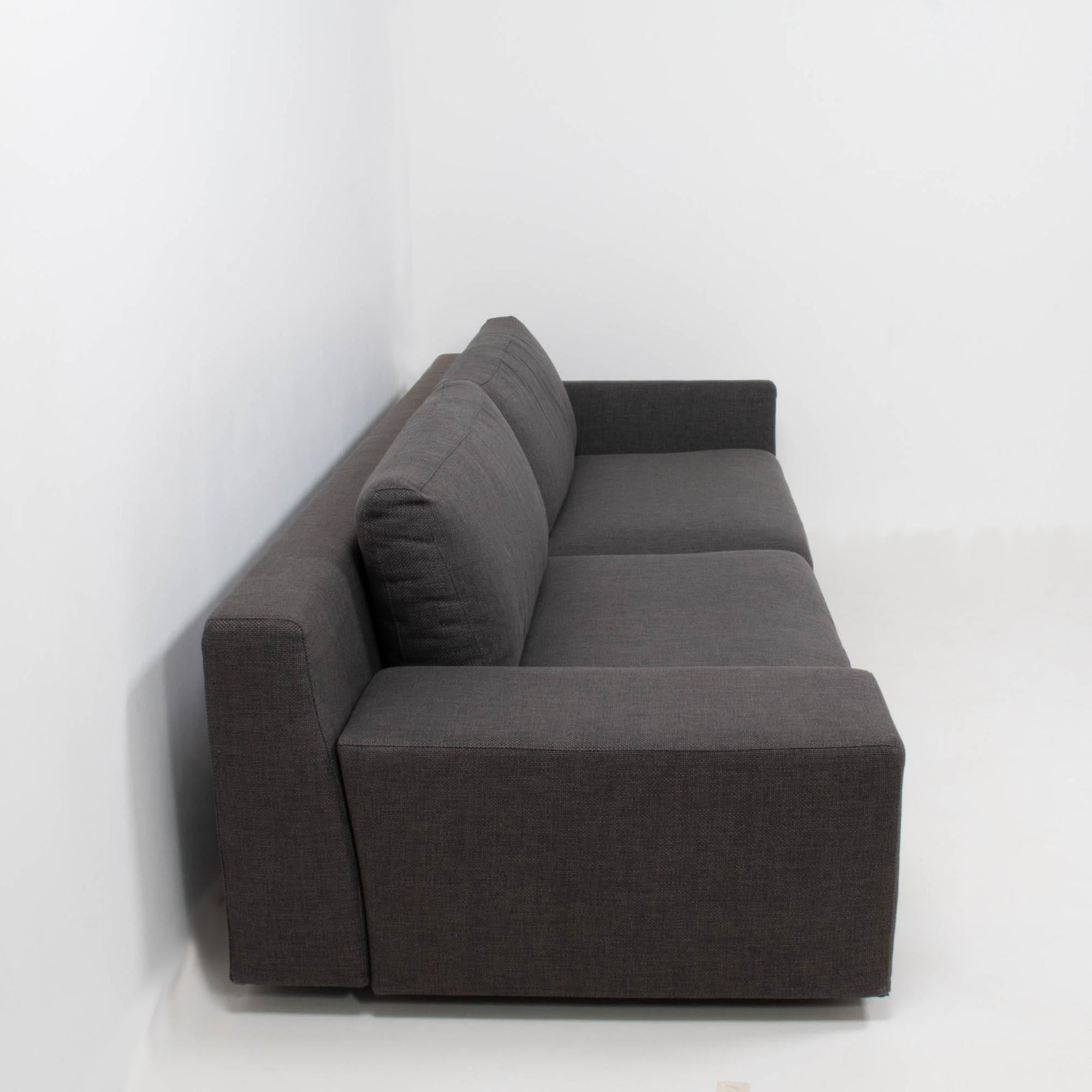 A fantastic example of contemporary design, this Mister sofa is designed by Philippe Starck for Cassina.

The sofa has a low back and deep seating, fully upholstered in dark grey woven fabric.

The sofa has an asymmetric silhouette, with one