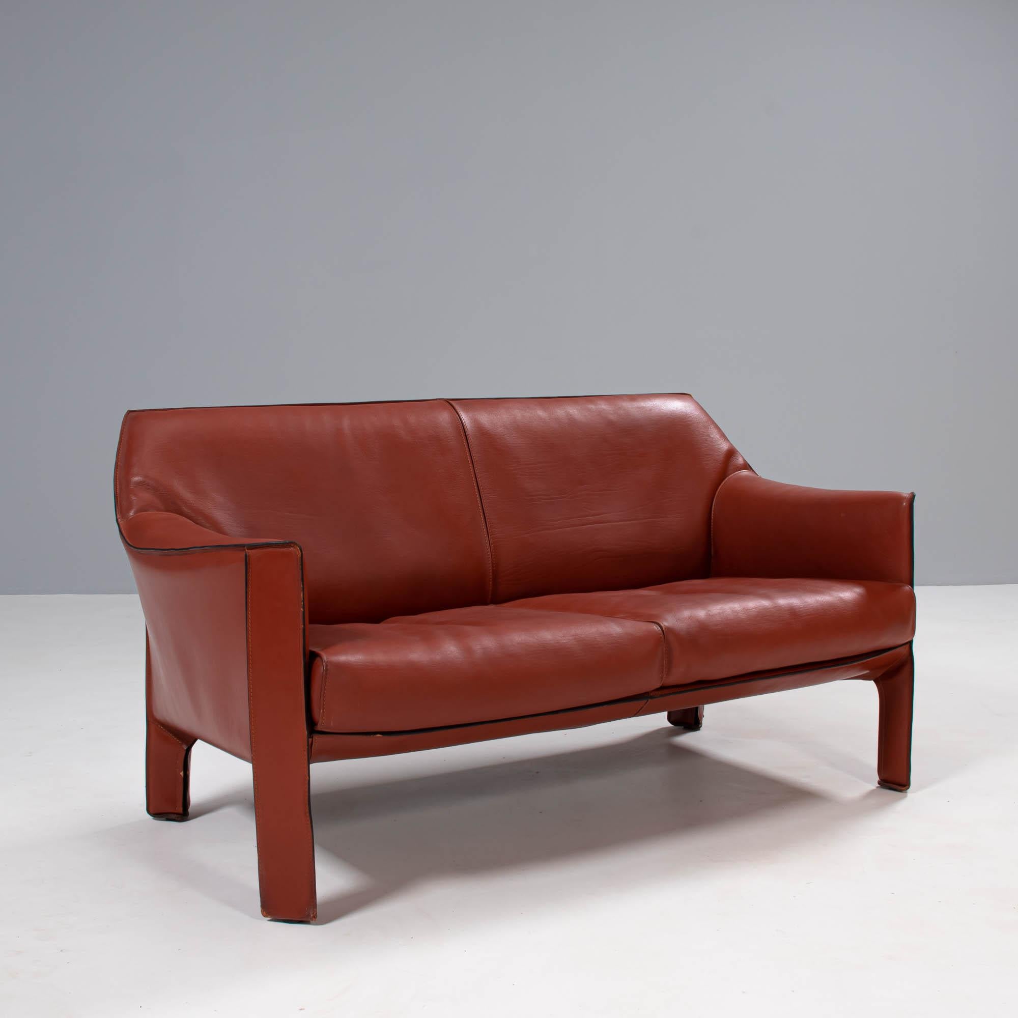 Originally designed by Mario Bellini in 1977, the Cab sofa has since become a signature piece in the Cassina furniture collection.

The sofa is constructed from a steel frame, completely covered in cognac leather upholstery, held in place with zip