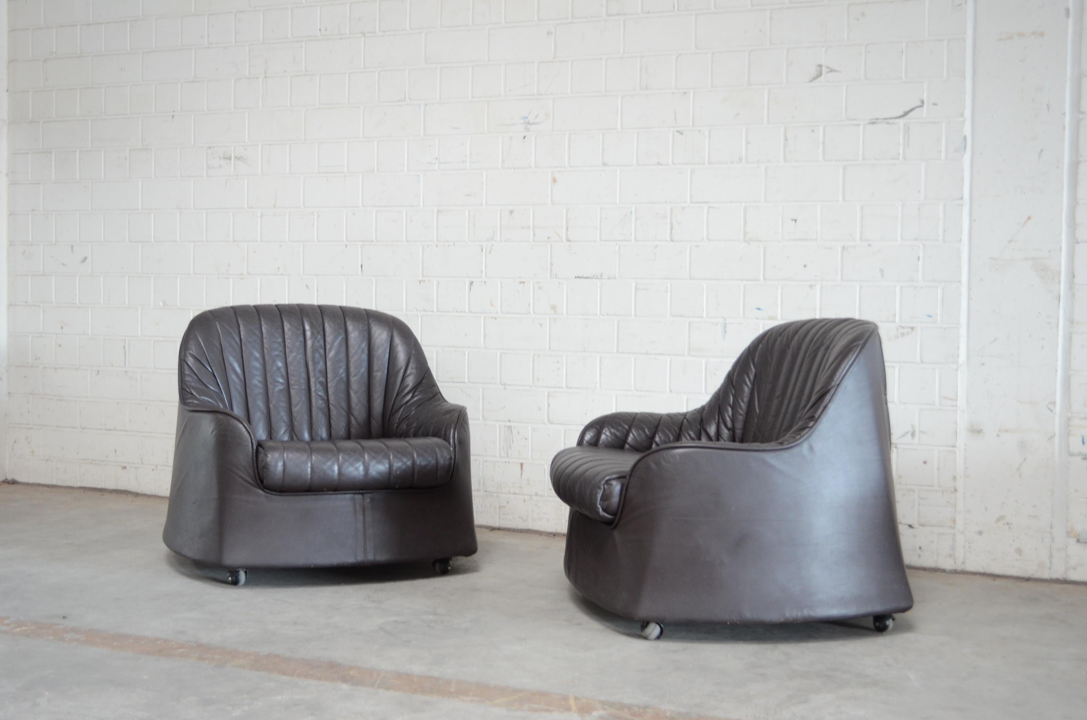 This pair of dark brown leather armchairs made of injection moulded polyurethane foam with a plywood base and rubber roller feet.
It was designed by Italian Architect and designer Tobia & Afra Scarpa 1968 for Cassina
The model Ciprea was one of