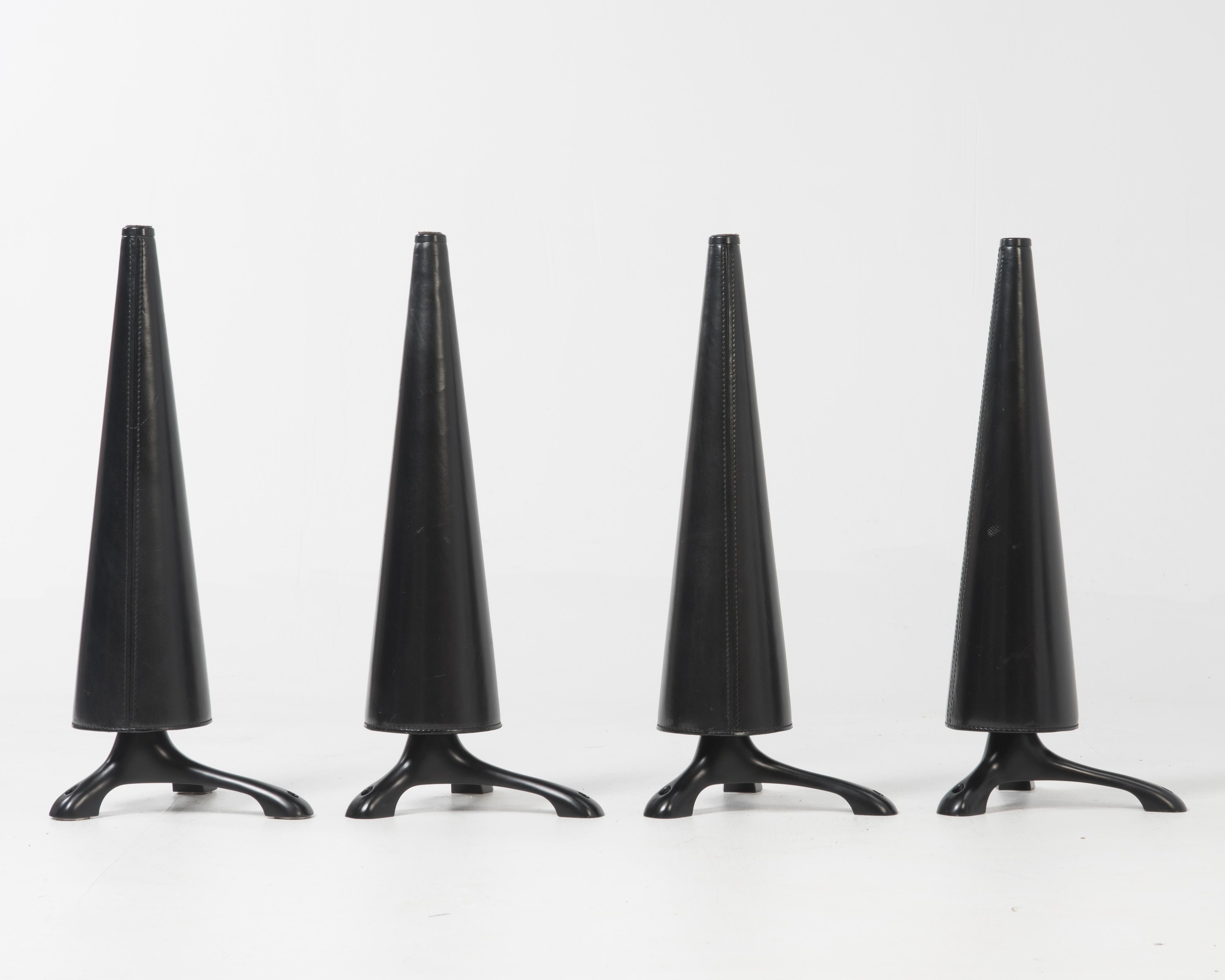 Four screw-on conical legs for the Oskar (or Oscar) table designed by Isoa Hosoe for Cassina in 1991.

Each leg has three contact points to attach the legs to a glass table top. The fifth photograph shows the three screw on discs that any