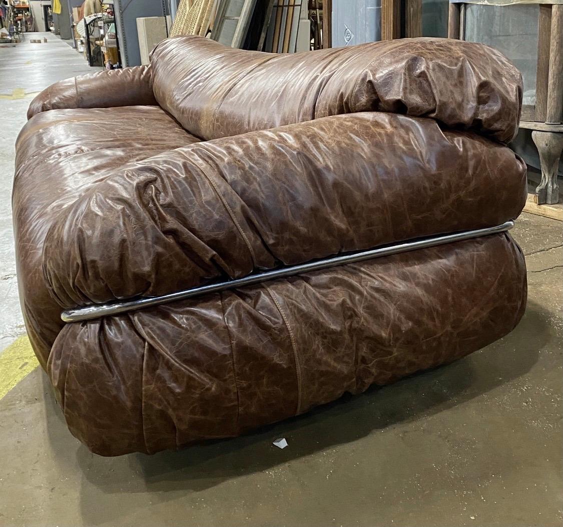 Mid-Century Modern, newly upholstered in distressed brown leather, Cassina large sofa that measures
92