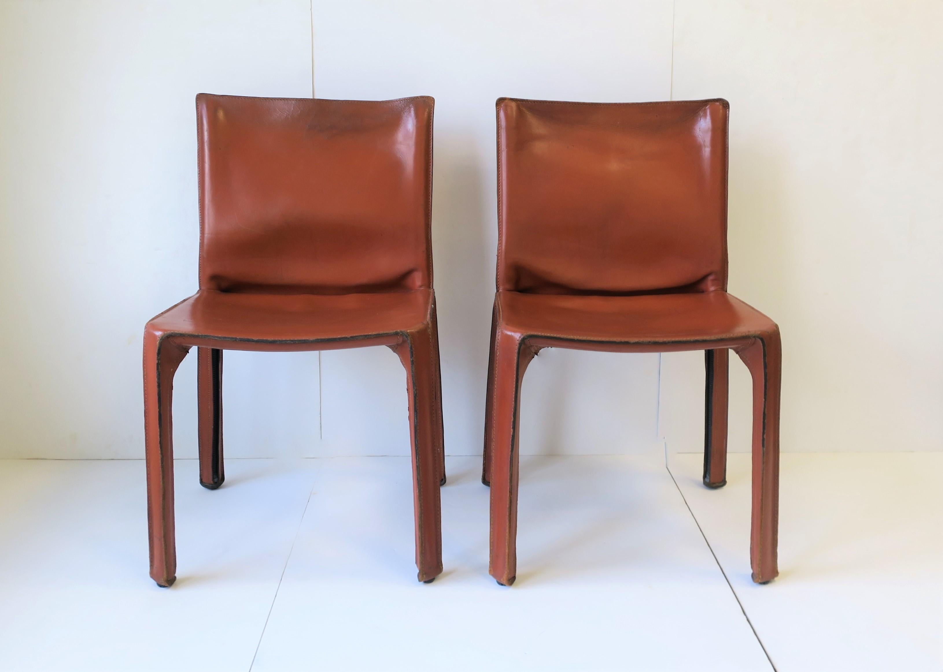 Iconic leather 'Cab' side chairs designed by Mario Bellini for Cassina. Chairs are being offered as 'per item' price. Buy one or two. There are two available. Leather is a 'honey brown' hue. 
 