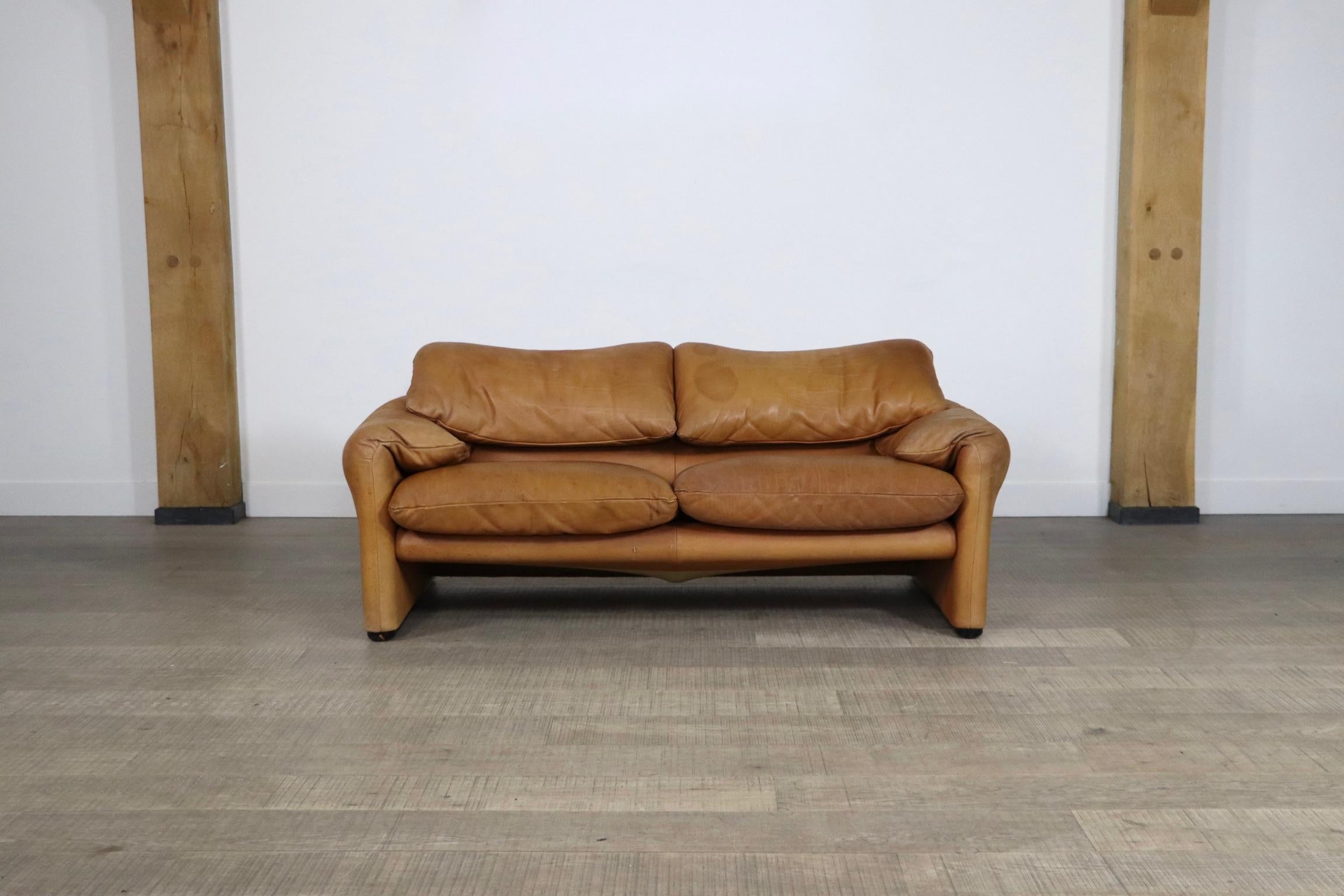 Stunning two seater Maralunga sofa, by Vico Magistretti for Cassina in the original cognac leather upholstery which has obtained a beautiful patina over the years.
This design is known for its high comfort and adjustable backrests. The vintage