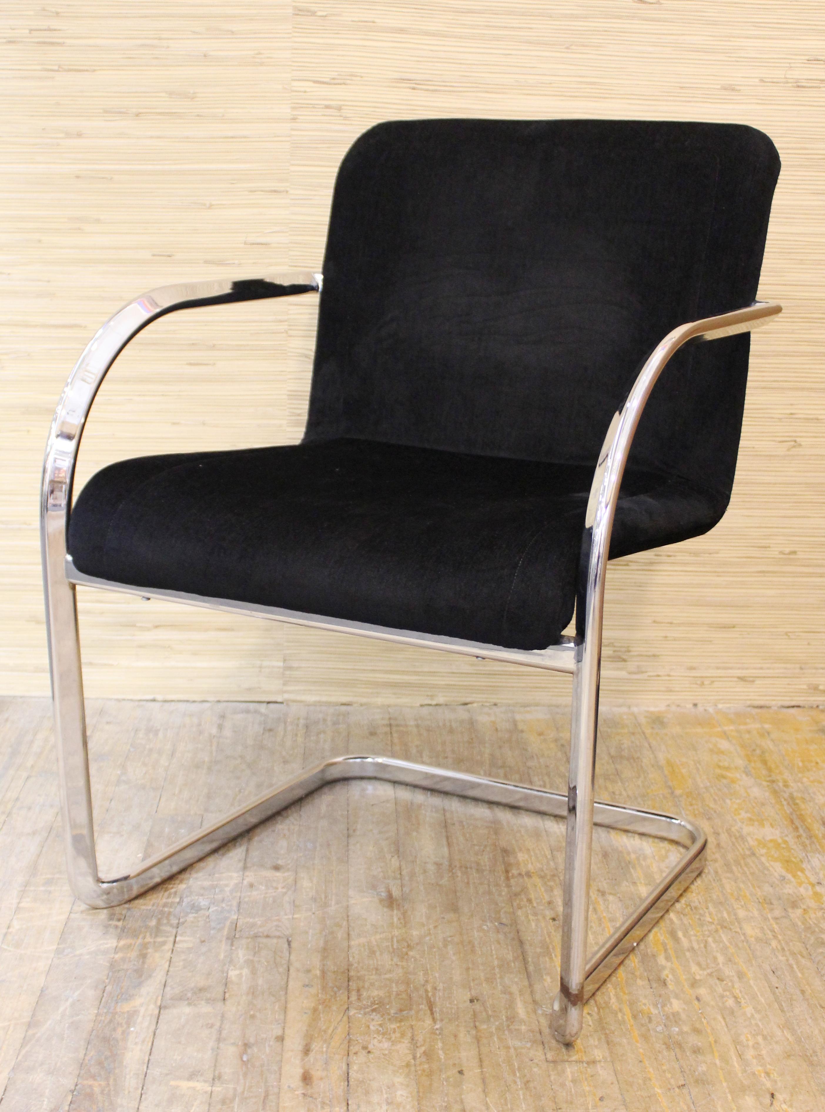 Modern set of four dining chairs with armrests in chromed metal structure with upholstery, designed by Cassina during the 1970s. The set is in great vintage condition with age-appropriate wear.