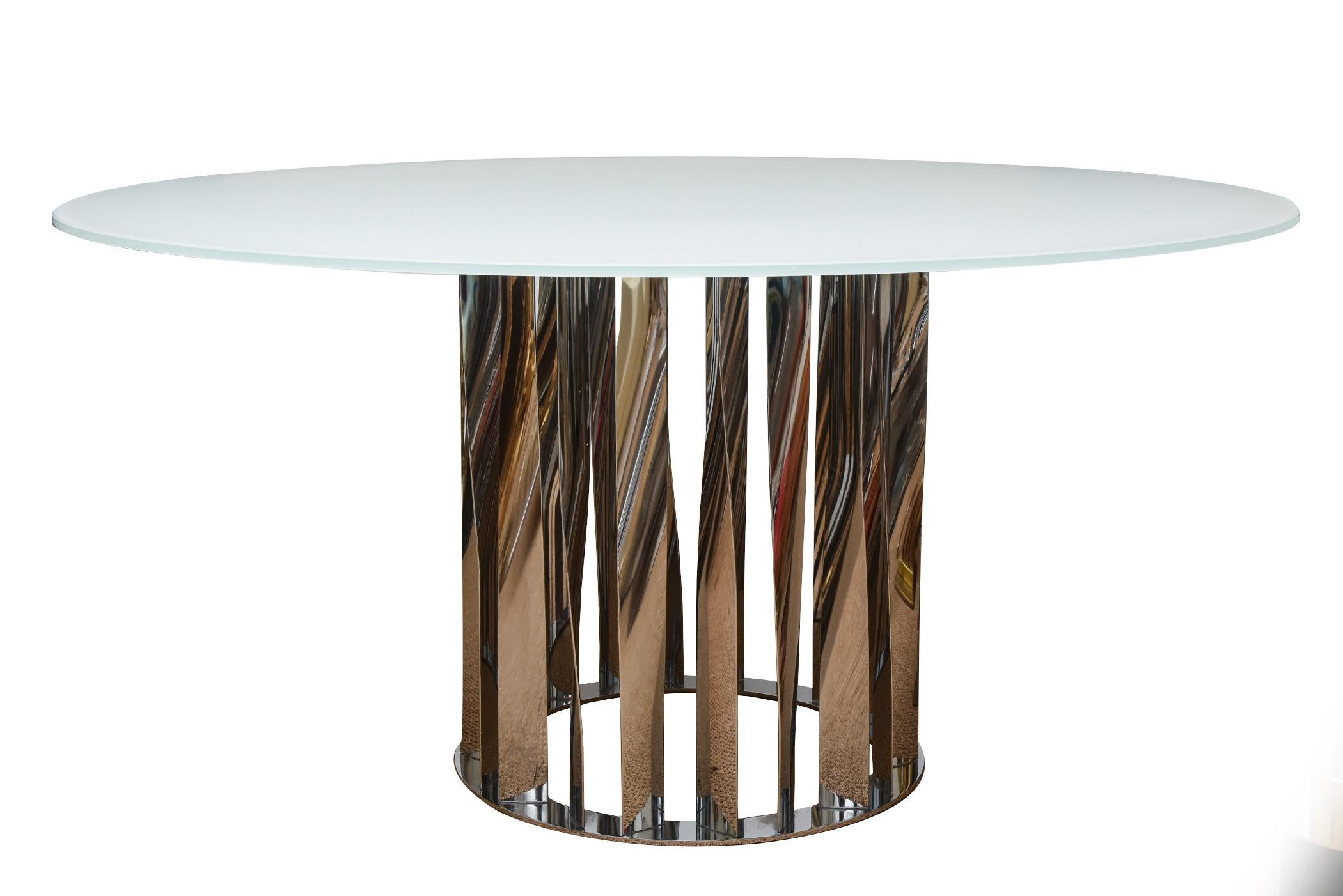 This Italian modern and contemporary round dining table or desk or entry table designed by Rodolfo Dordoni for Cassina is from about 2012. The original glass top is white milk glass and the base is rhythmic patterns of chromed mylar that look like