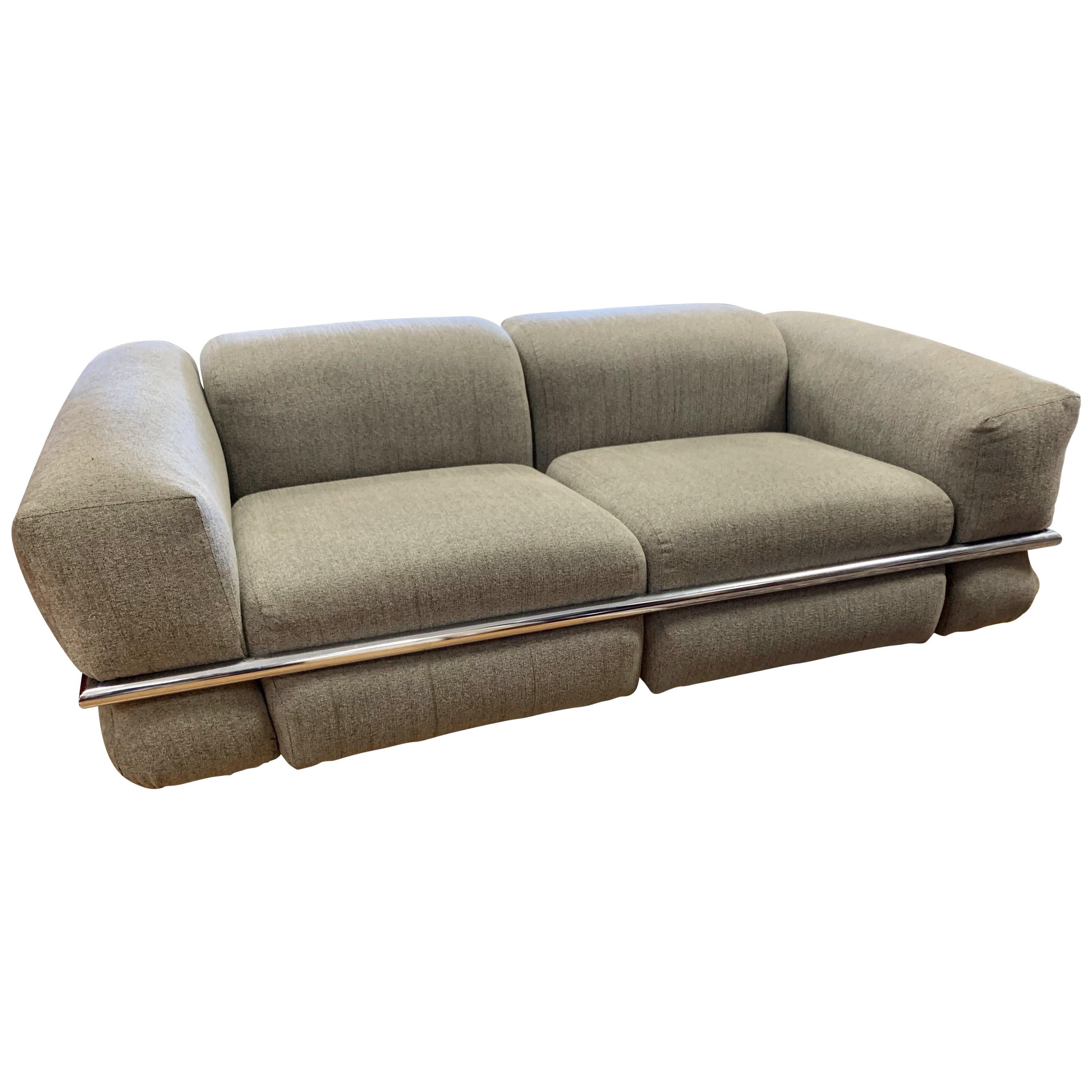 Stunning Cassina Sesann sofa by Gianfranco Frattini, the second of two we have. Designed in 1969 in Italy. The fabric is a solid gray and its signature is the chrome plated steel that runs around the sofa. All original, circa 1970's and still in