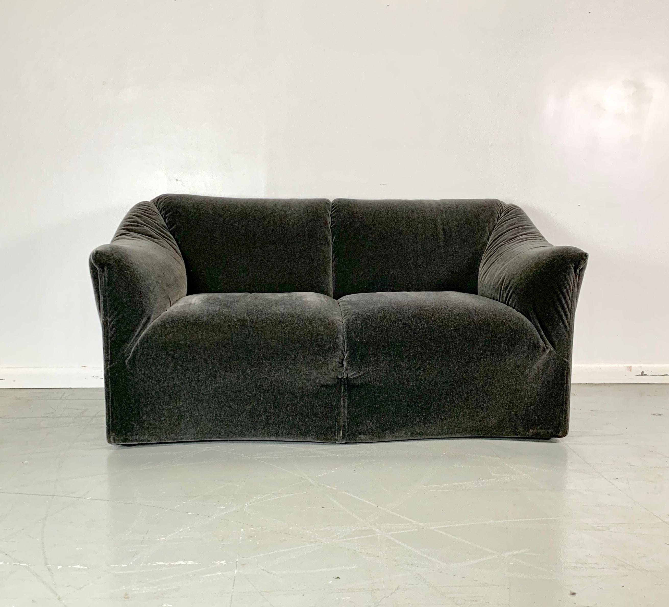 Designed in the early 1970s, the Tentazione loveseat is considered model #685 by Cassina and was distributed by Atelier International Limited (ai), and has similar styling as the La Bambole sofa. Constructed by a metal frame on a wooden base and