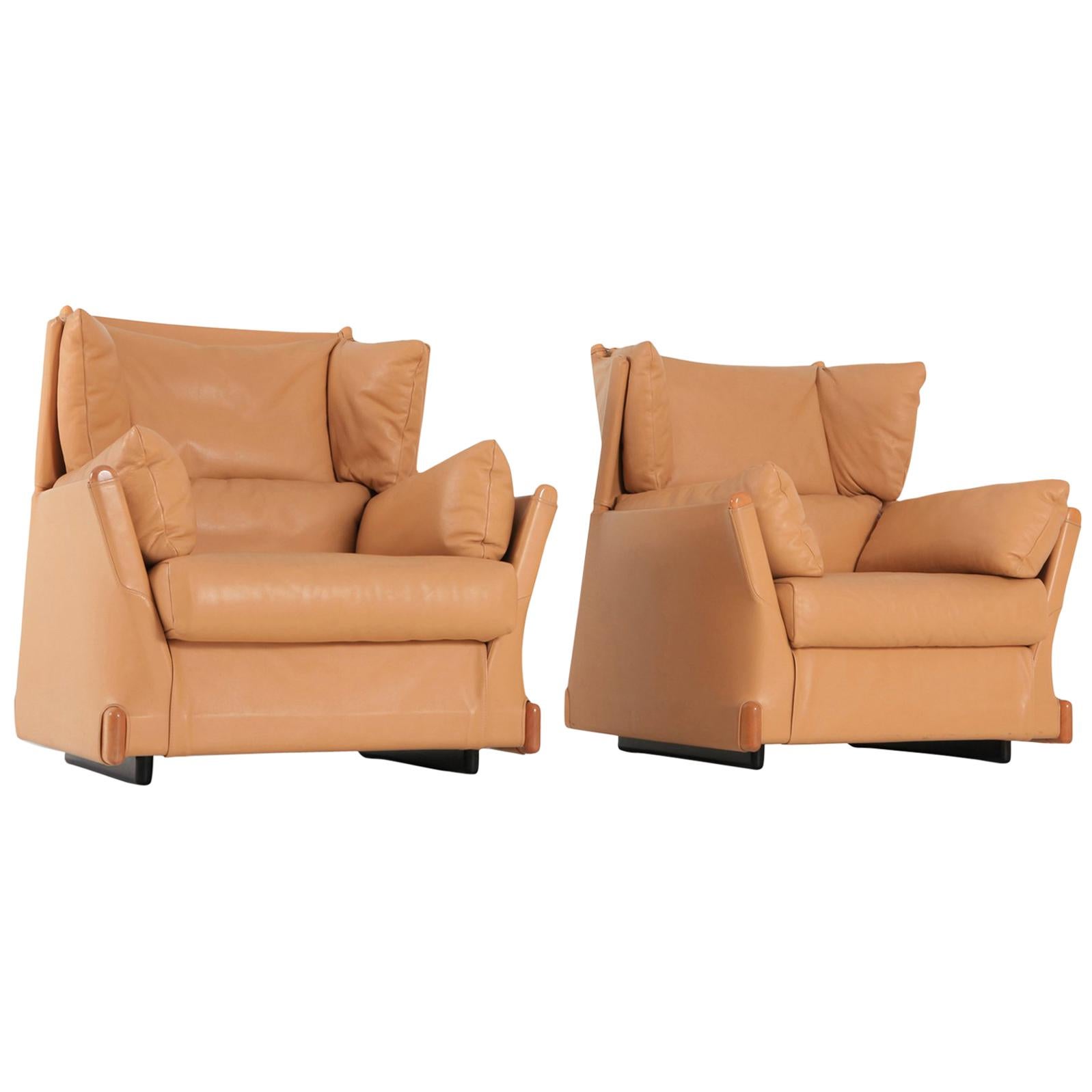 Postmodern luxury lounge chairs, Piero Martini for Cassina, 1970s.
The camel leather and wooden details are in exceptionally well preserved condition.

Down filled cushions make these club chairs very comfortable too.

  
