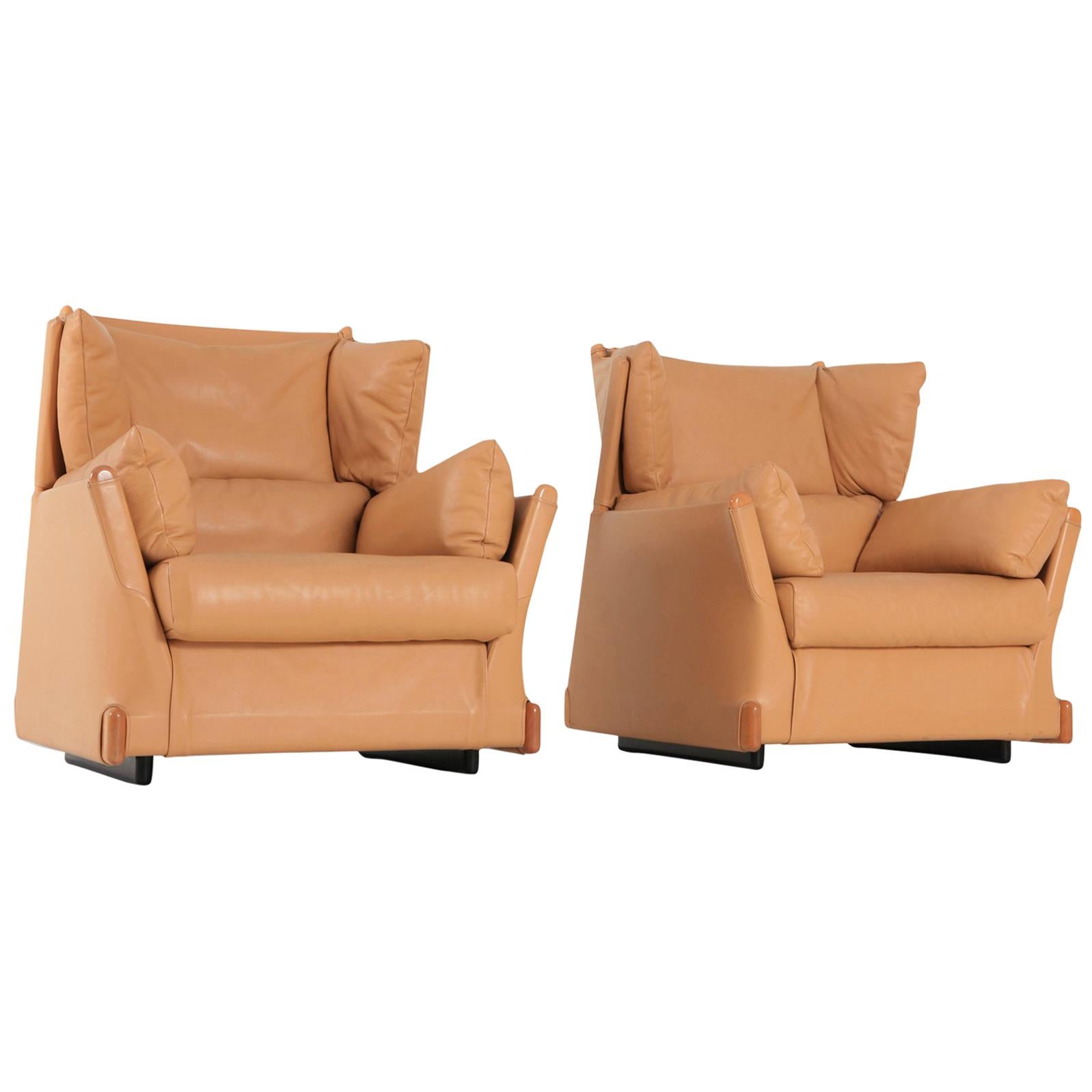 Postmodern luxury lounge chairs by Piero Martini for Cassina, 1970s.
The camel leather and wooden details are in exceptionally well preserved condition.

Down filled cushions make these club chairs very comfortable too.

 