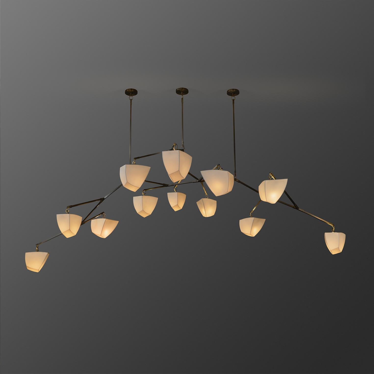 Cassiopeia 13: Porcelain is a large horizontal mobile chandelier with thirteen handmade translucent porcelain polyhedrons and three hanging points. 

This special version of the Cassiopeia Series was designed to float horizontally extending in two