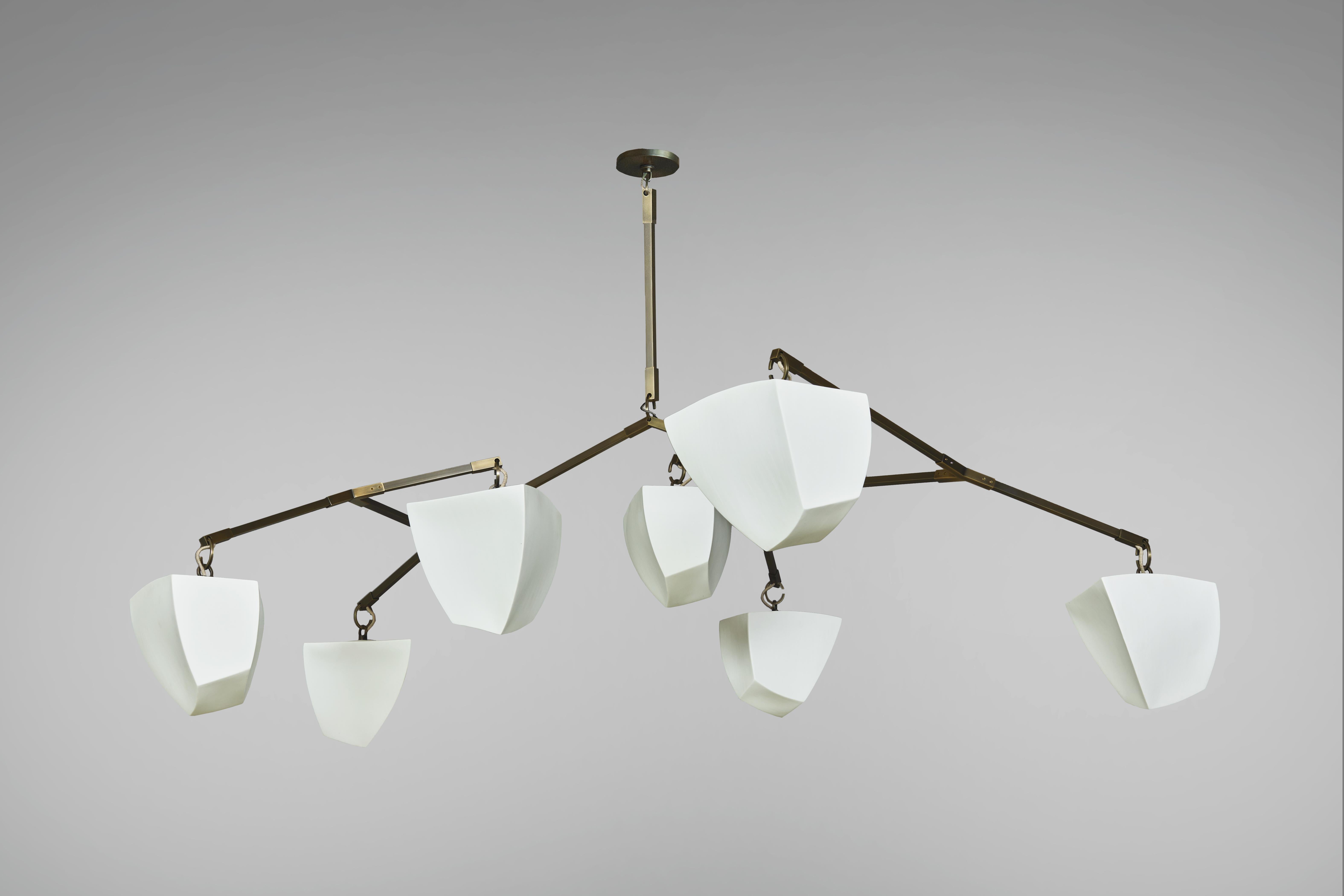 This is a horizontal mobile chandelier with 7 glowing cast porcelain polyhedrons.

The Cassiopeia series was designed for spaces with lower ceiling heights where a horizontal chandelier is needed.

Our unique mobile chandelier system can be
