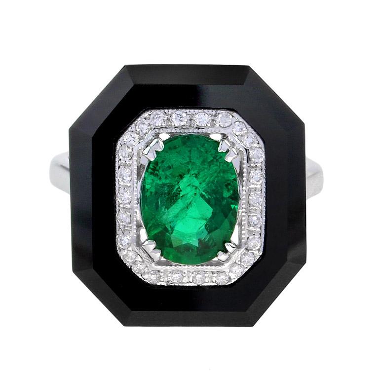 A striking and intriguing jewel, indeed. This big, bold, and colorful Art Deco style ring highlights a gorgeous gleaming emerald center stone, framed in a sparkling octagonal halo of round brilliant-cut diamonds, all set off with eye-catching