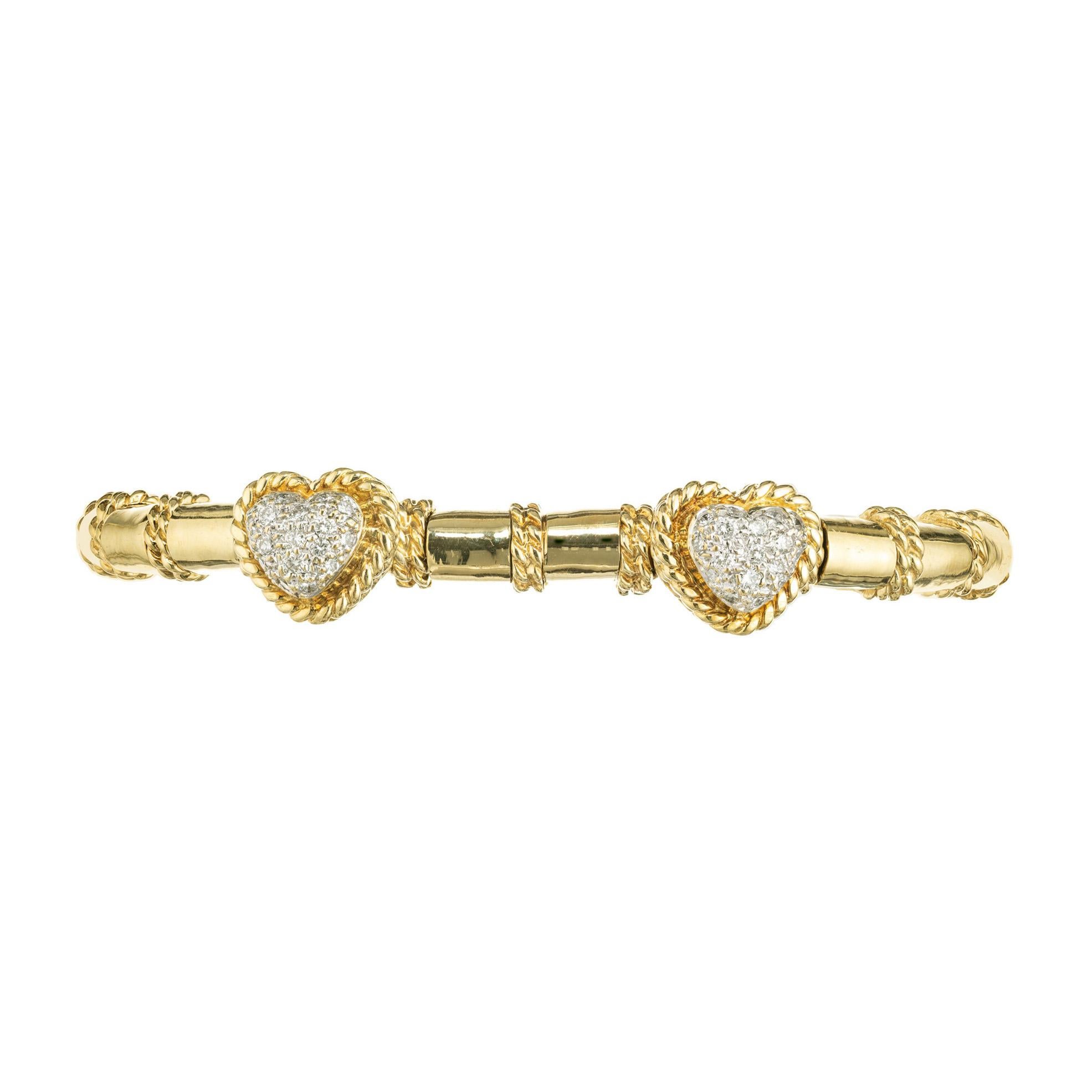 Cassis diamond dangle heart bracelet. 34 round full cut diamonds set in double twisted gold wire heart shapes, set along an 18k yellow gold slip on bracelet with twisted gold wire separators. Fits a 7-7.5 inch wrist. 

34 round full cut diamonds, G