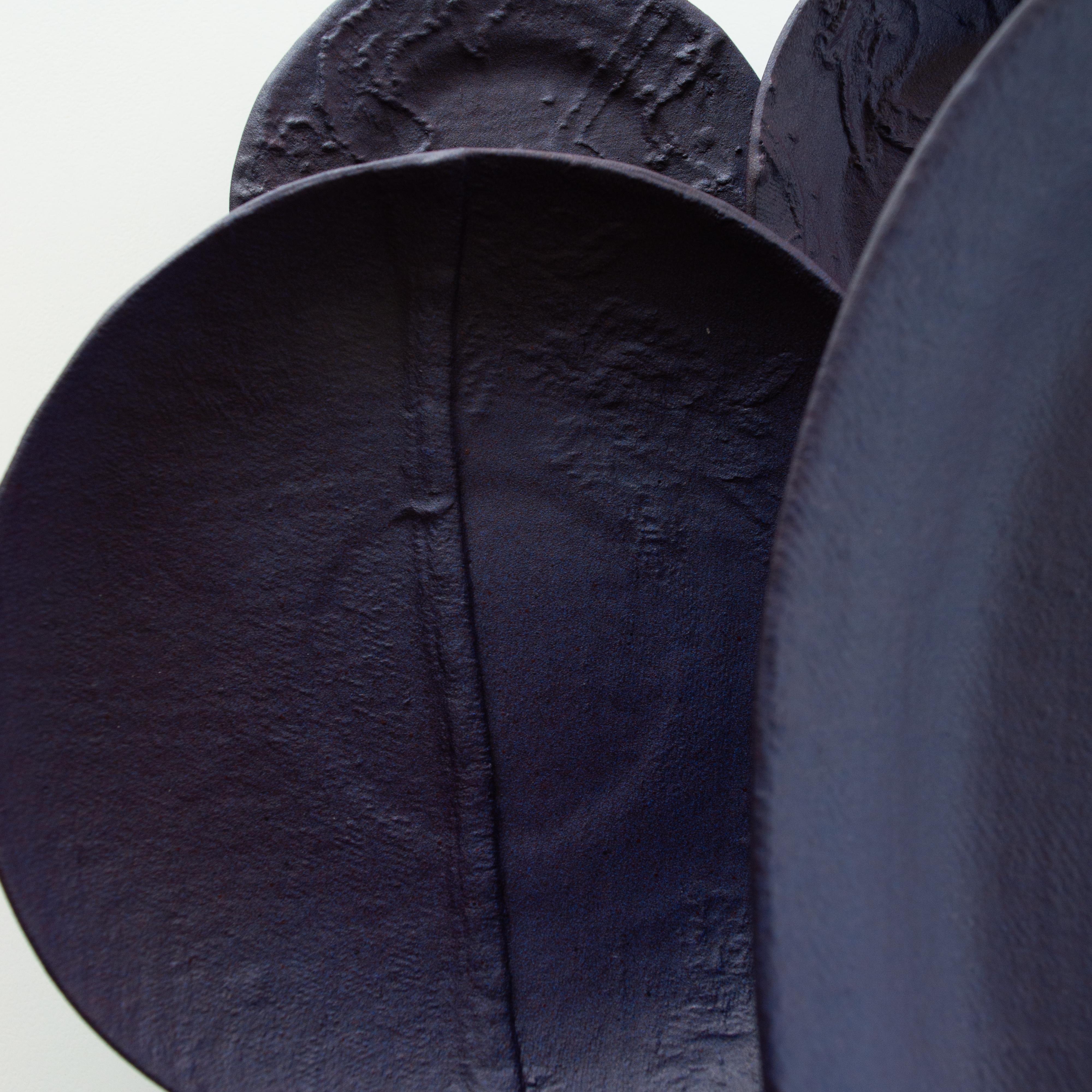 This installation consists of a group of hand made plates in porcelain with our signature fabric texture combined with heritage shapes.

The title Cassis (blackcurrant in French) references the letter C embroidery on the oval piece on the left of