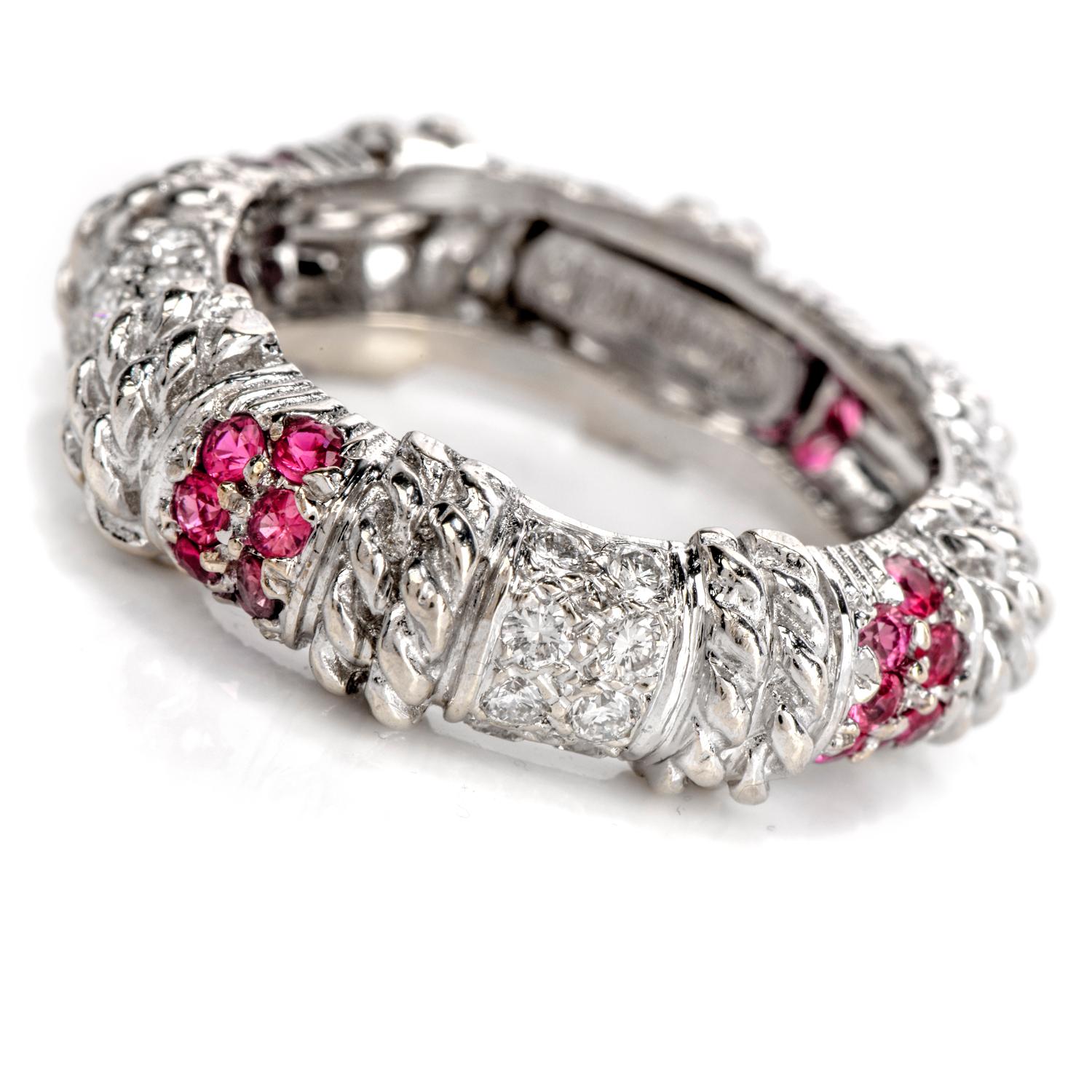 This alluring designer Cassis stack band ring crafted in 18K white gold is embellished with alternating sections of round cut white sparkling diamonds, lovely pink sapphires, and a rope style motif. This ring has a gram weight of approximately 6.91