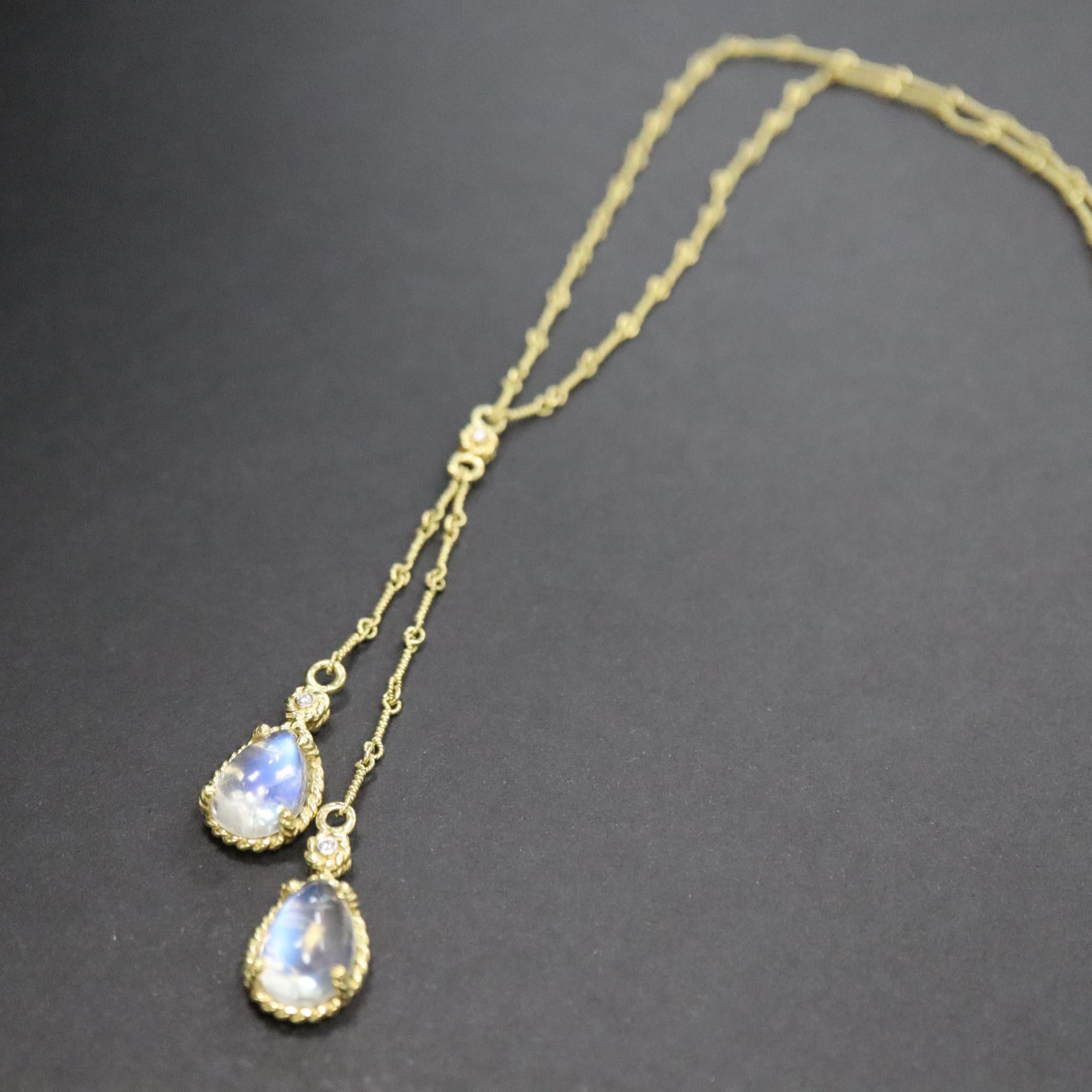 This beautiful Cassis Natural Diamond And Moonstone Lariette Necklace is crafted in 18K yellow gold with 3 white diamonds and 2 clear blue moonstones. The length of the necklace is 12 inches with total weight 12.8 g. Comes with a gift box and an